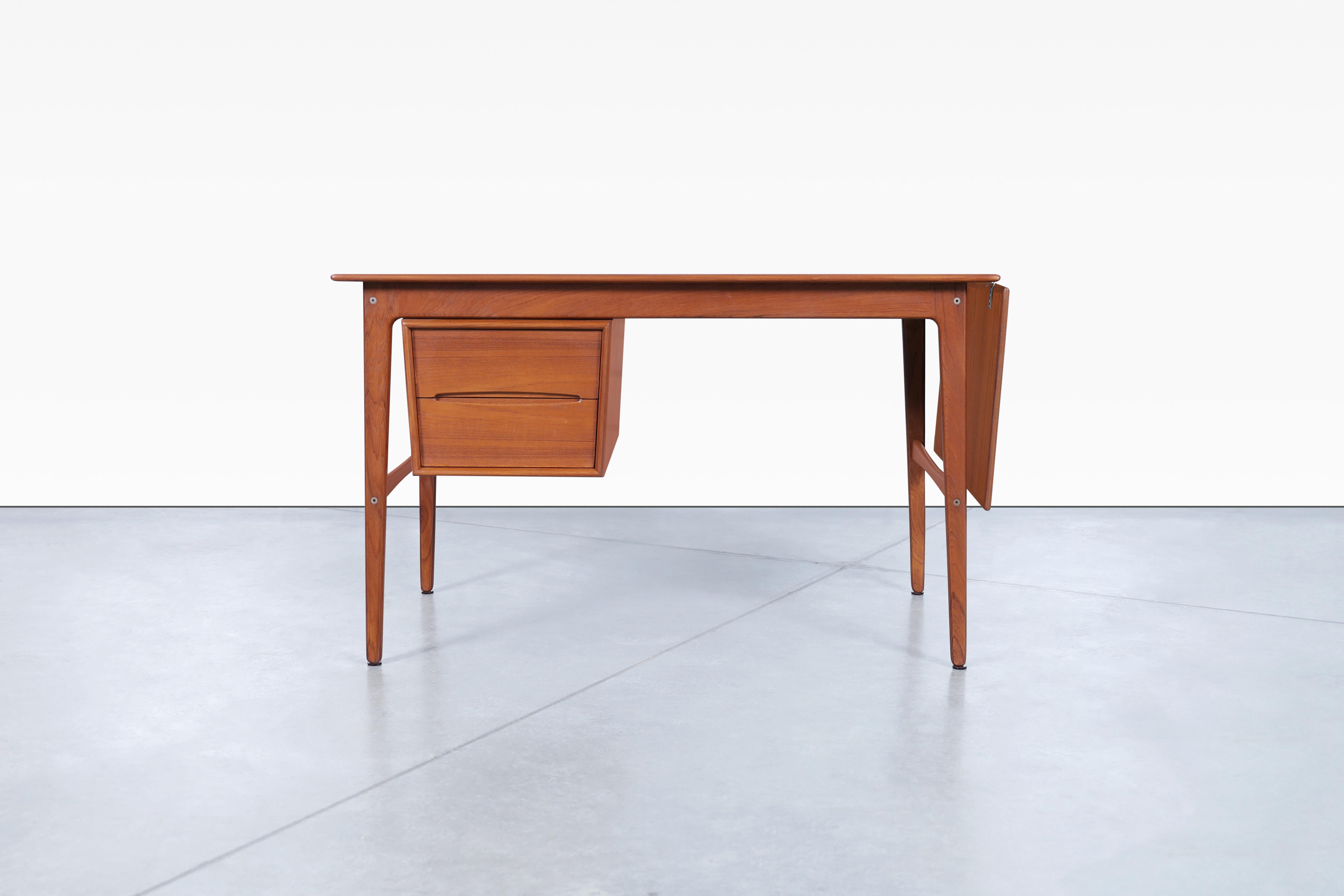 Wonderful Danish modern teak desk designed by Aksel Boll Jensen in Denmark, circa 1960’s. This gorgeous desk has been professionally refinished and features two beautifully crafted dovetail drawers. It's part of the incredible designs offered by
