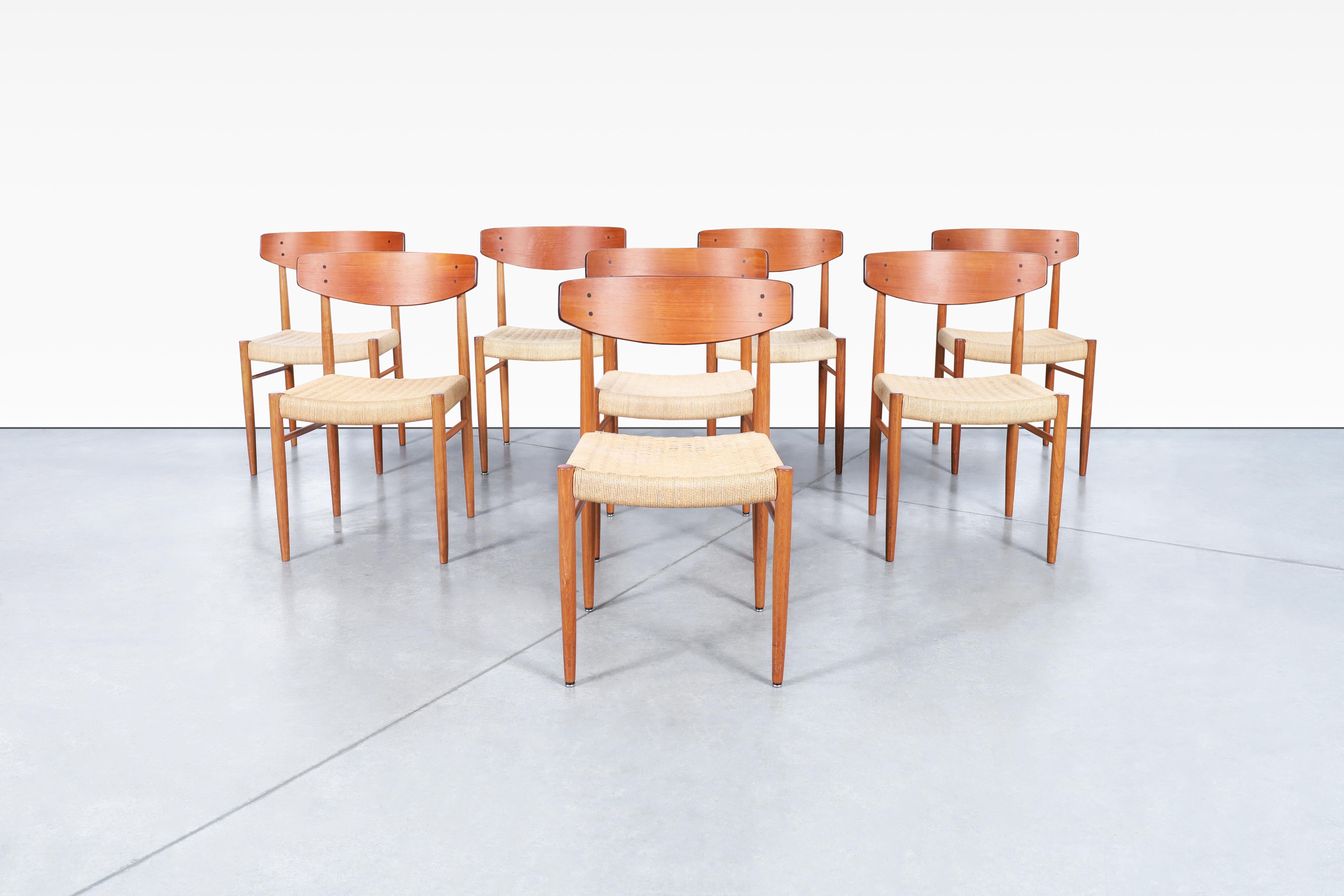 Stunning Danish modern teak dining chairs designed by AM Møbler in Denmark, circa 1960s. These famous chairs, also known as Model 501, are designed with precision and showcase an iconic shape; these dining chairs feature a solid teak frame adorned