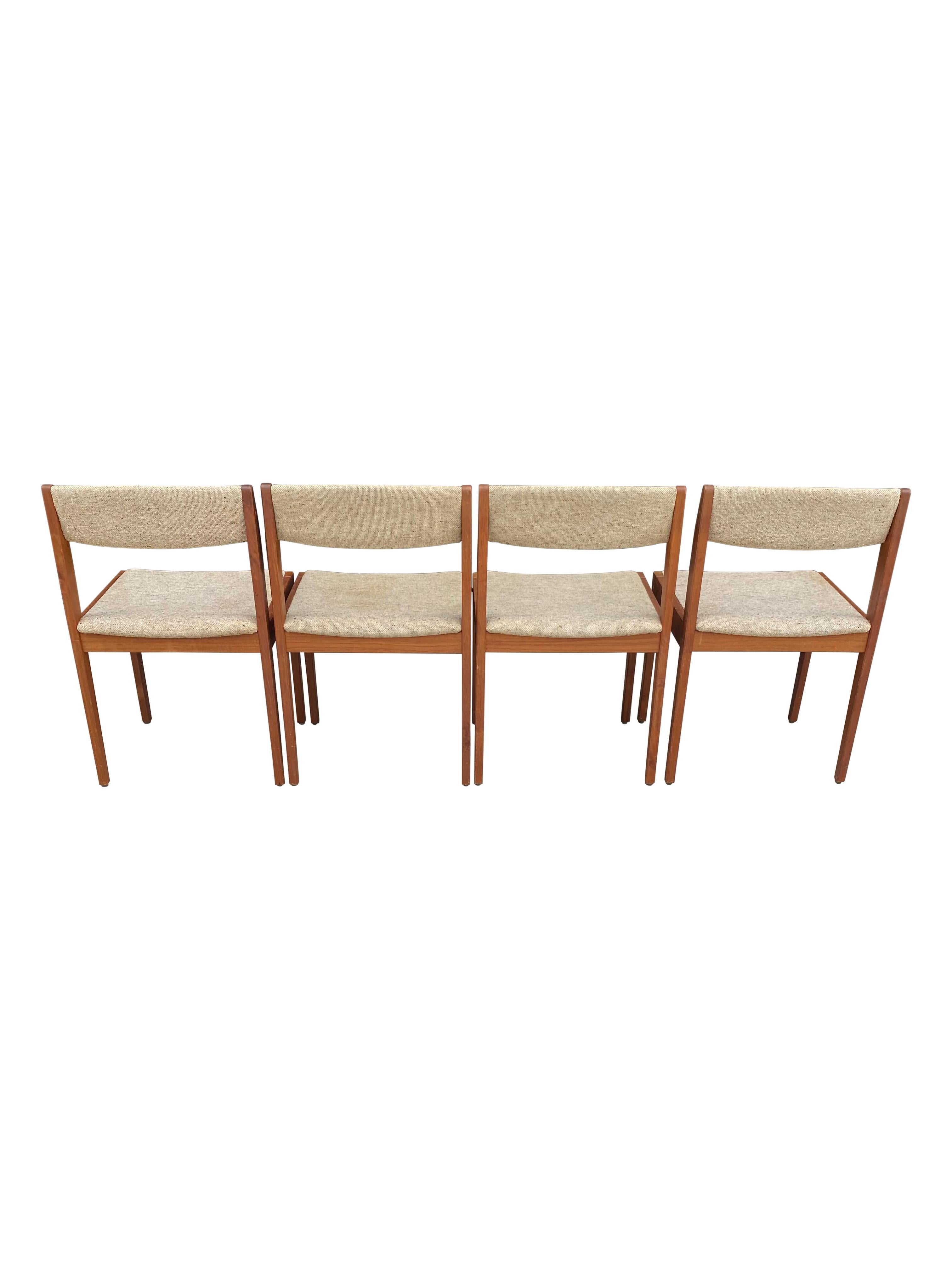 Great set of classic Danish modern dining chairs. Executed in trak and original upholstery. Even wood tones throughout and structurally sound. Signed underneath the seat. Easy to reupholster if you prefer another color or textile.