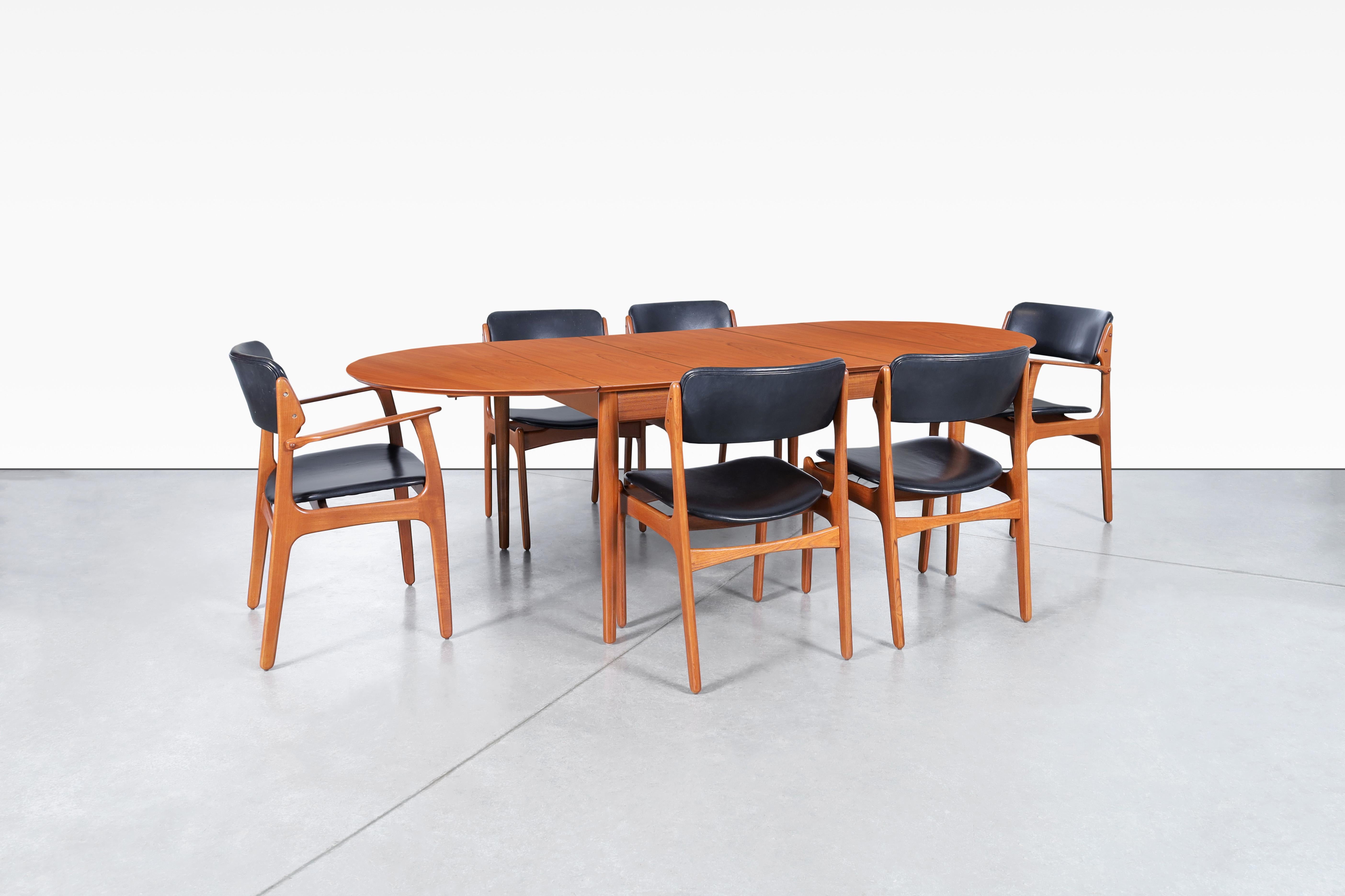 Transform your dining space into a mid-century masterpiece with this stunning dining room set that combines iconic design with exquisite craftsmanship. This set includes six dining chairs and a Danish modern teak dining table, designed by Erik Buch