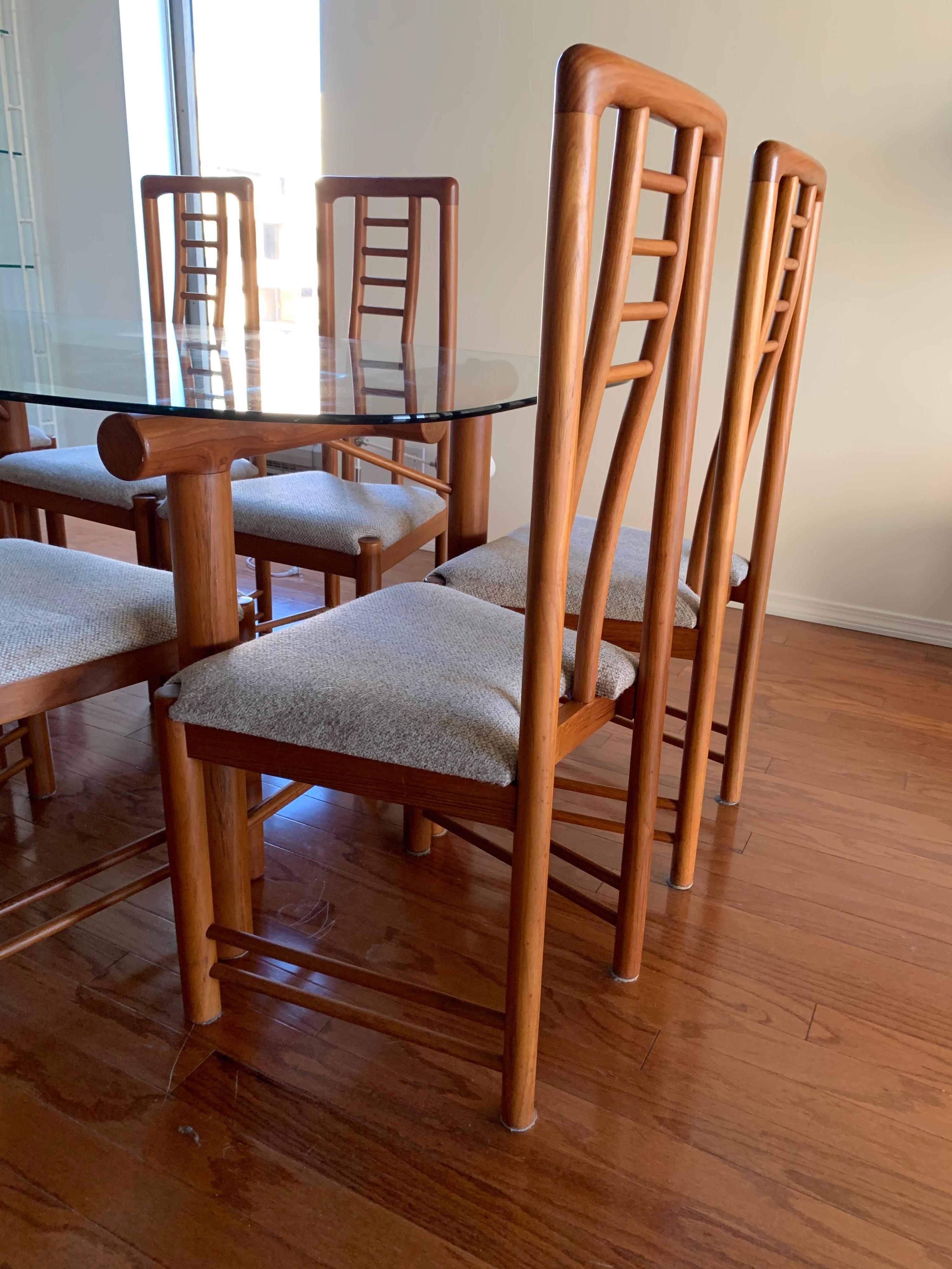 Elegant 1970’s Danish modern dining room set features a glass top dining table with eight matching ladderback side chairs. There are no manufacturer hallmarks on any of the pieces. The table can seat eight quite easily. Dimensions of the table are