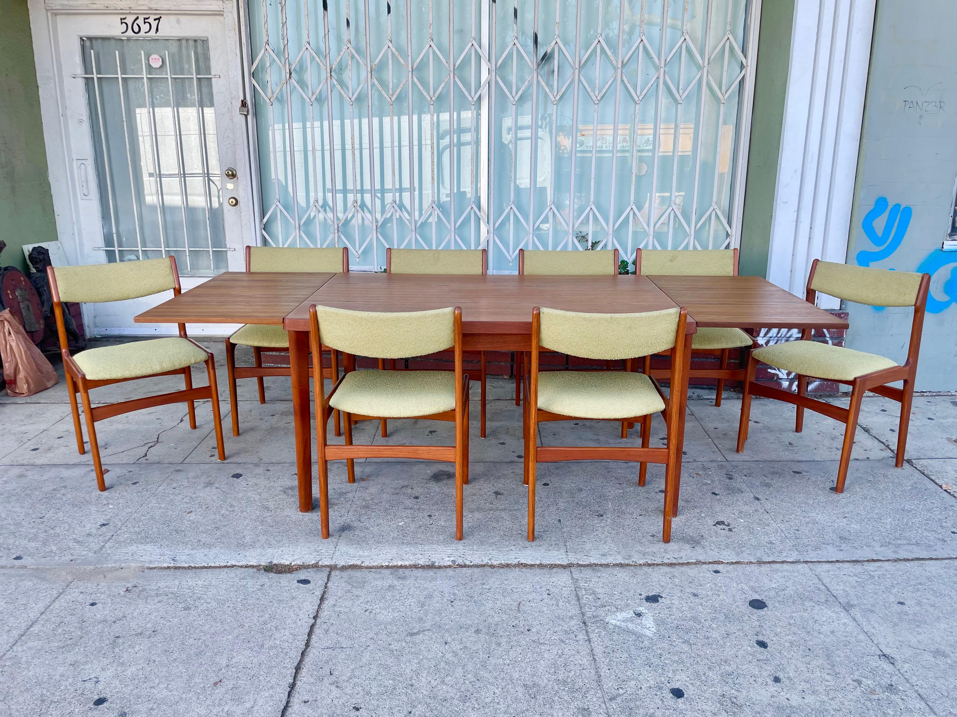 Danish modern teak dining set designed and manufactured in Denmark circa 1960s. This beautiful dining room set consists of two pull-out extensions that are easily pulled out and extended, giving you and your guest plenty of space. The set also comes