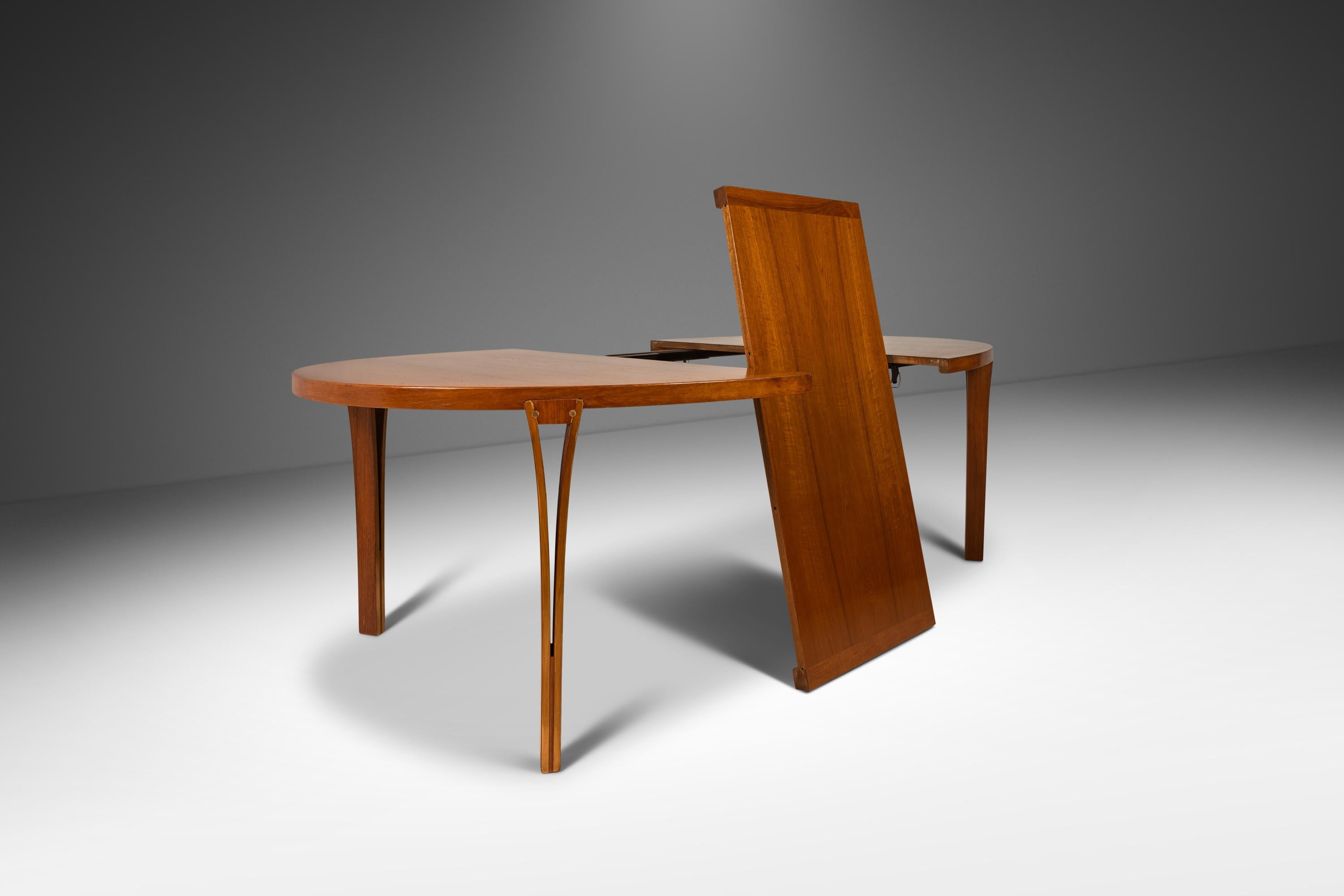 Introducing a rare and exquisite expansion dining table by the renowned Sven Ellekaer for Heltborg Møbler. Designed in the early 1960s, this stunning table is a true representation of mid-century modern design and craftsmanship.

Constructed from a