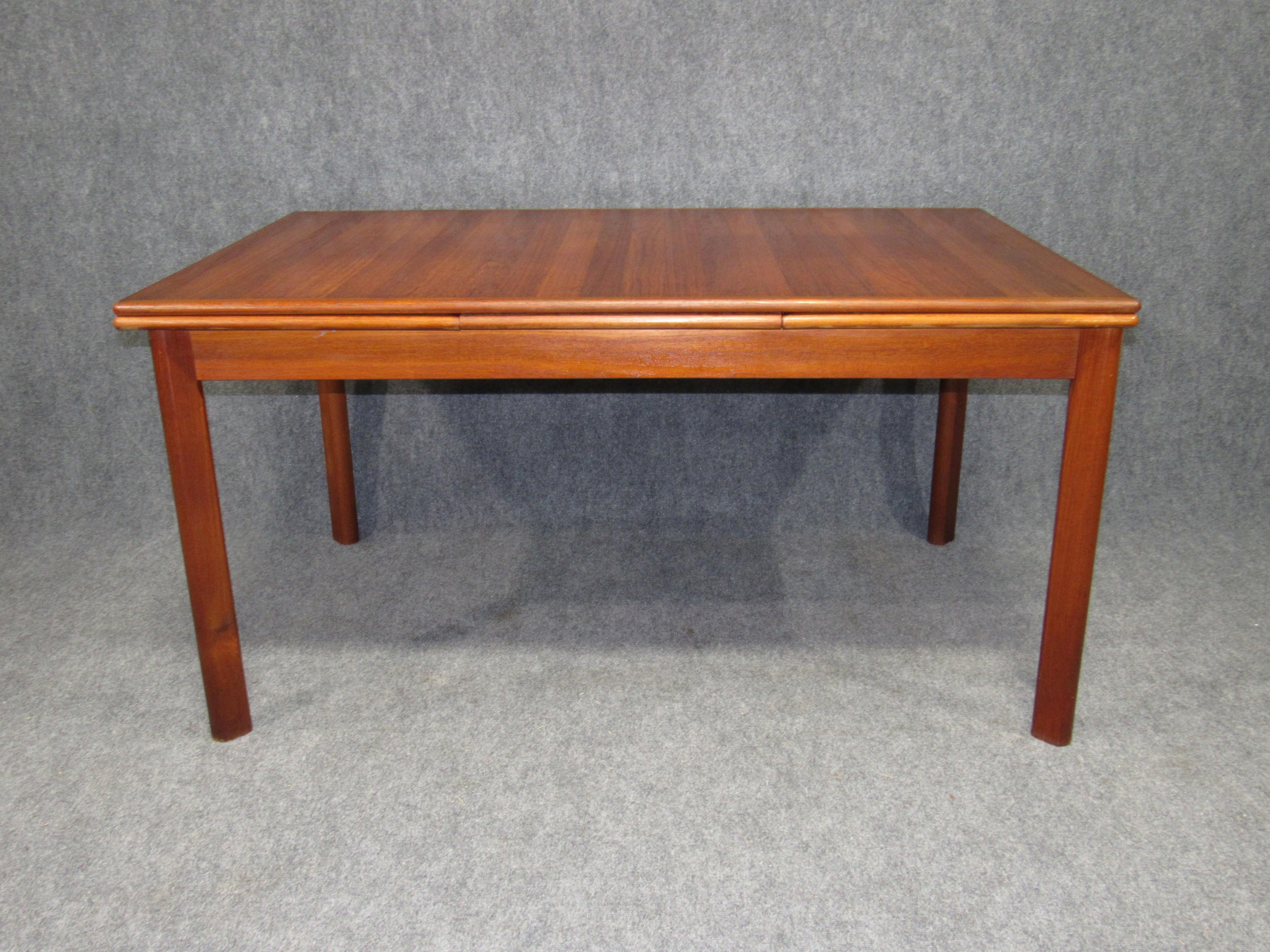 Danish modern teak dining table with pullout / pull-out leaves.
