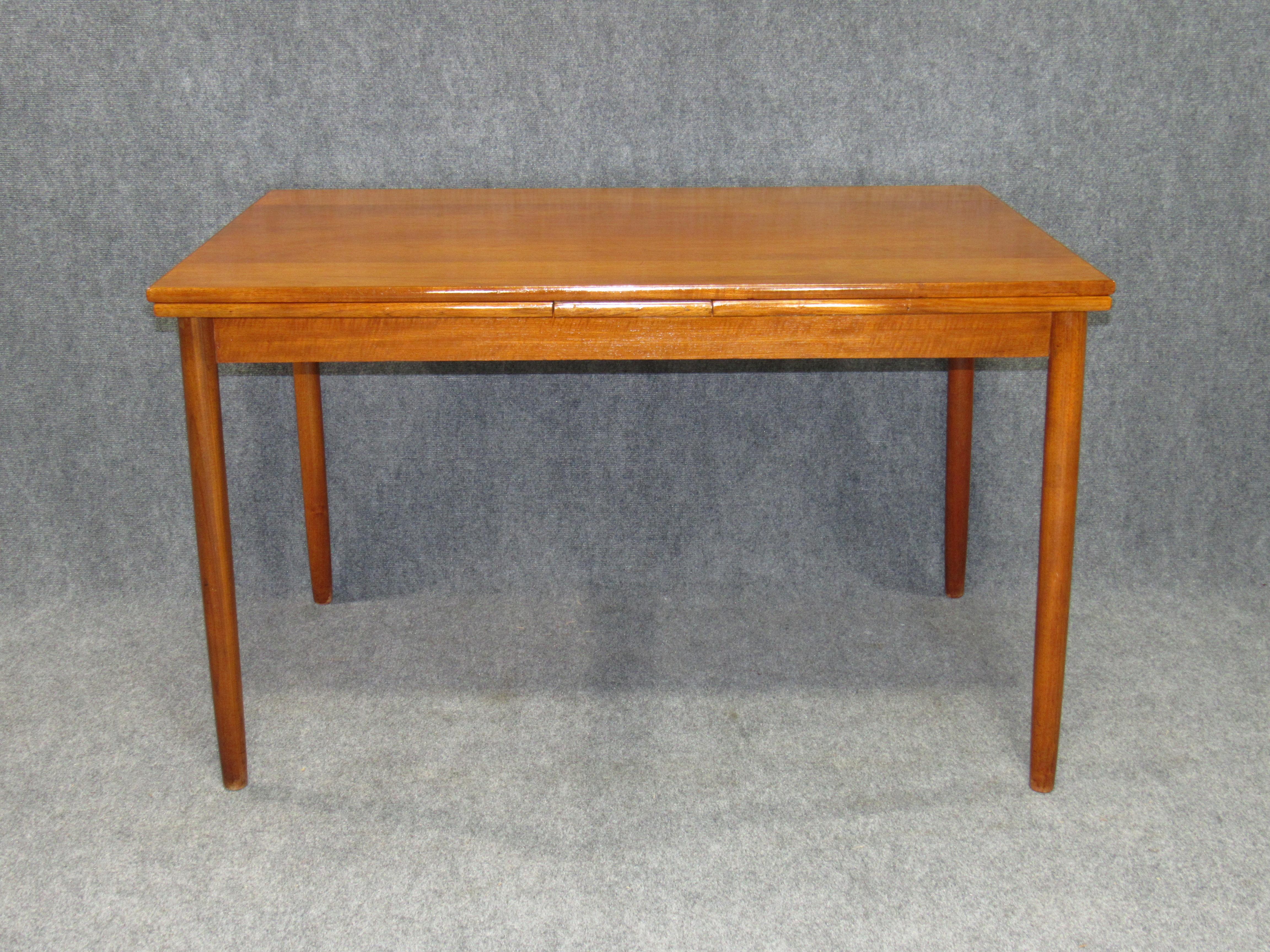 Danish modern teak dining table with pull out leaves. Dimensions are 47.5