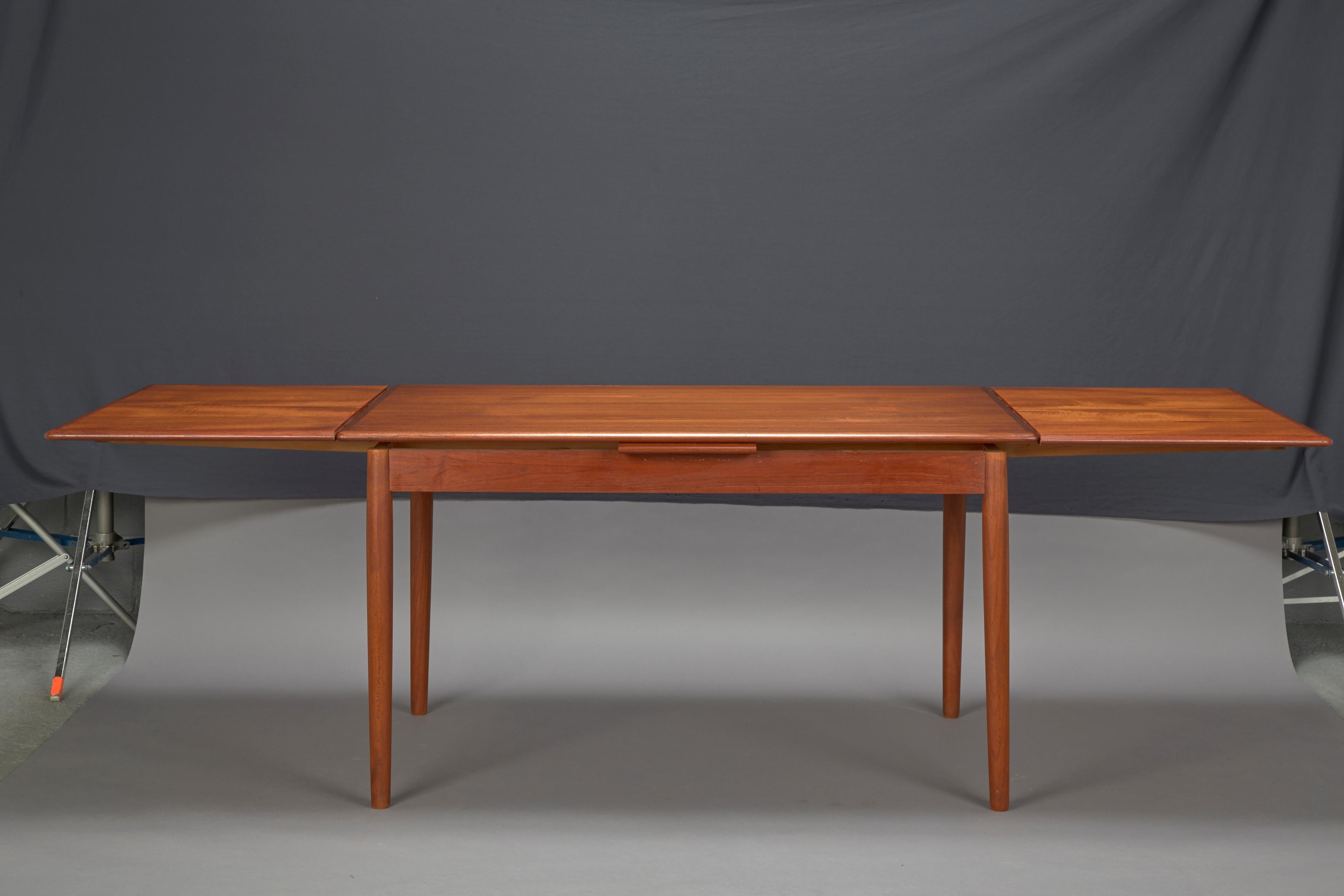 Danish modern dining table with two pull-out leaves
This table has 2- 20.5