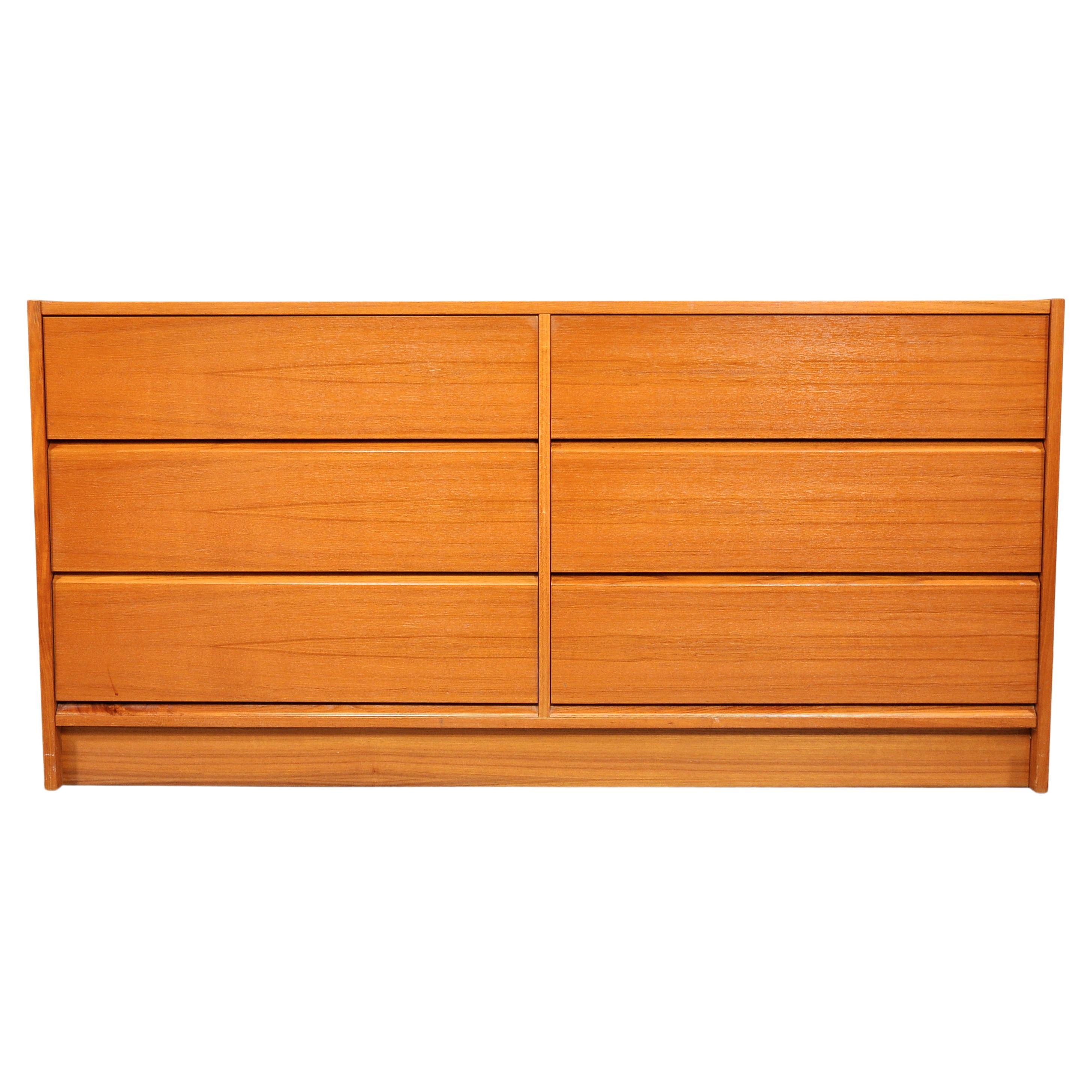 A vintage Mid-Century Modern teak double dresser from Denmark with beautiful wood grain. Both gorgeous and functional, this Scandinavian Modern chest of drawers dates from the 1970s. With 6 large drawers, it provides a ton of storage space. The