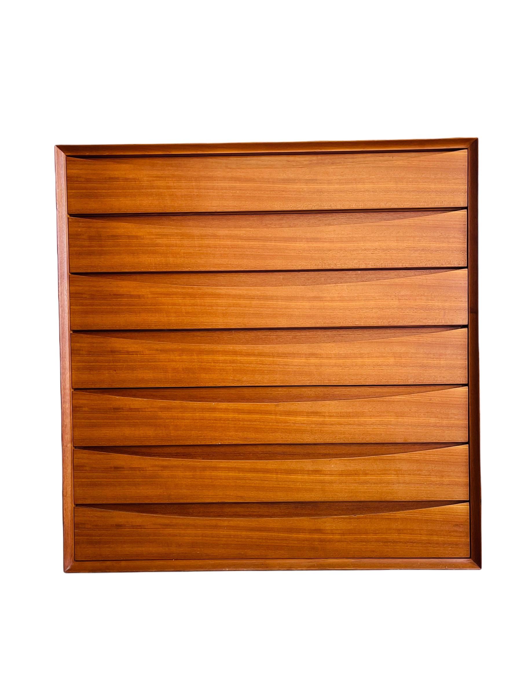 Here is a stunning Danish Modern teak dresser by Arne Vodder for Sabist Furniture of Denmark. The dresser is equipped with seven sculpted front dovetail drawers, dividers and a sliding tray on the top drawer. The dresser is in good vintage condition