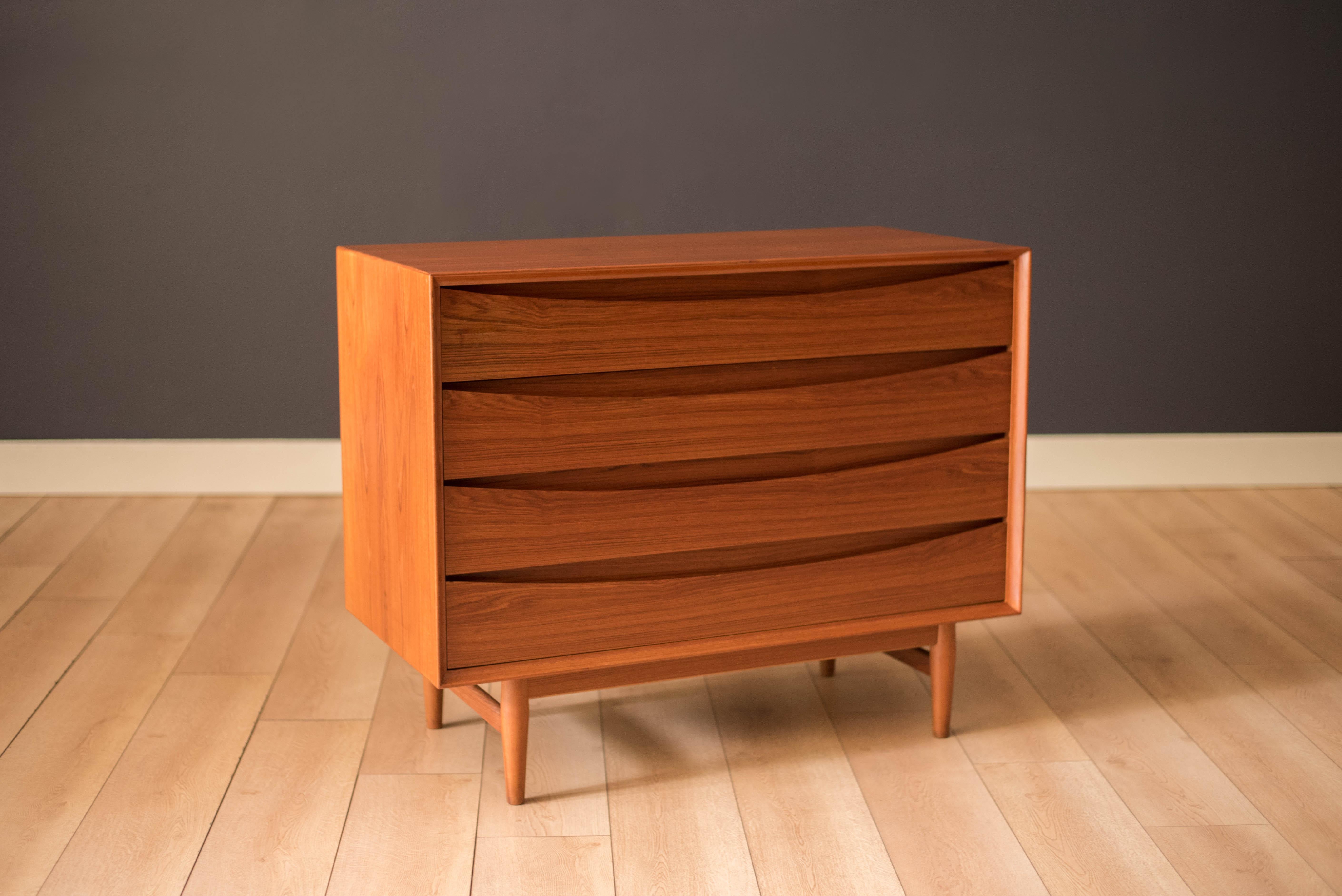 Mid-Century Modern dresser chest in teak designed by Arne Vodder for Sibast Furniture, circa 1960's. Created with an exceptional skill of cabinetry, this case piece is built with four dovetailed drawers, signature sculpted handles, and deep storage