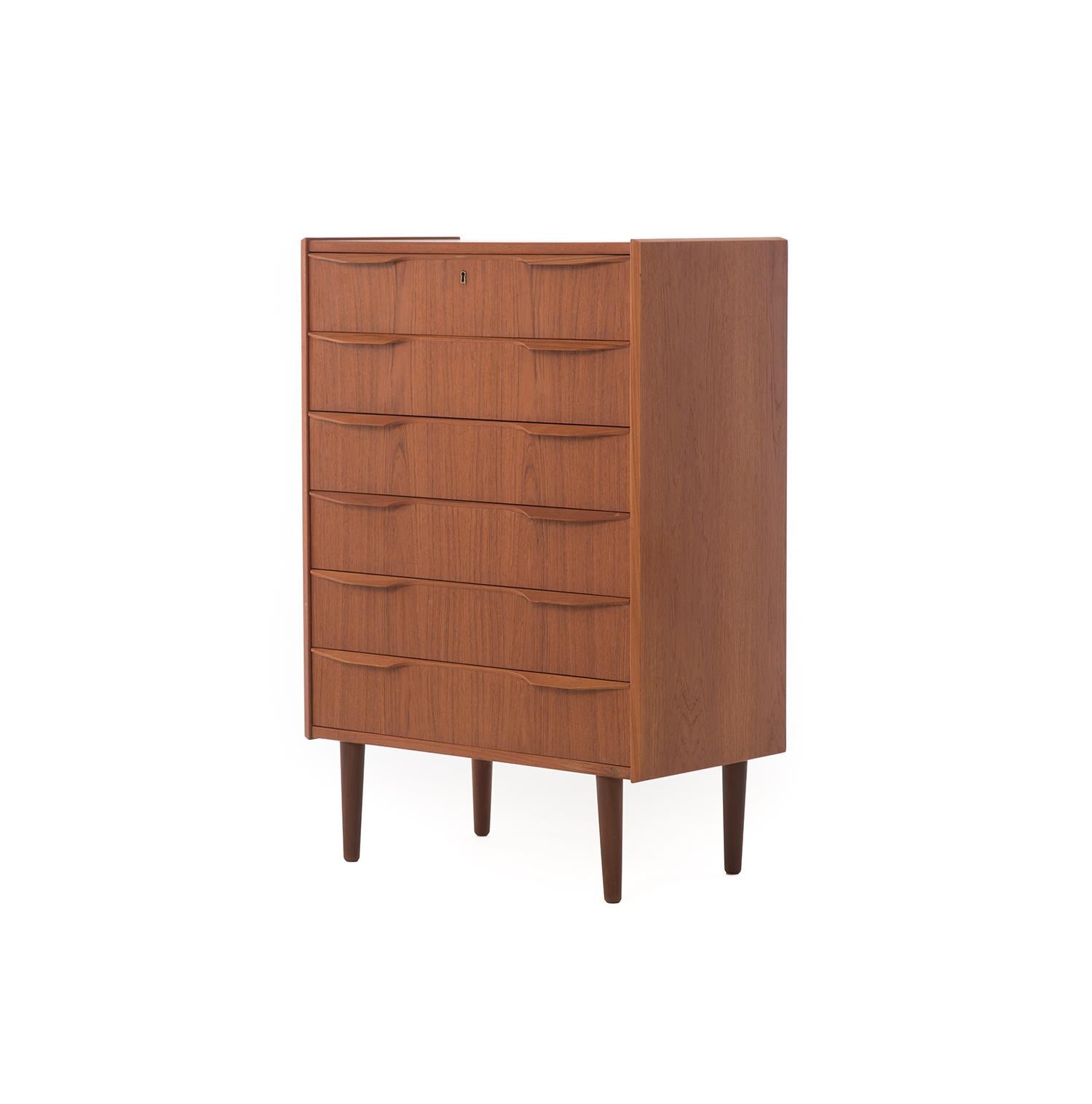 A delicate wood grain and winged pulls set this restored Danish teak dresser apart from all other midcentury highboy dressers. Six drawers, equal in size, provide ample storage for all your daily necessities; folded and otherwise. Measuring at 31 W