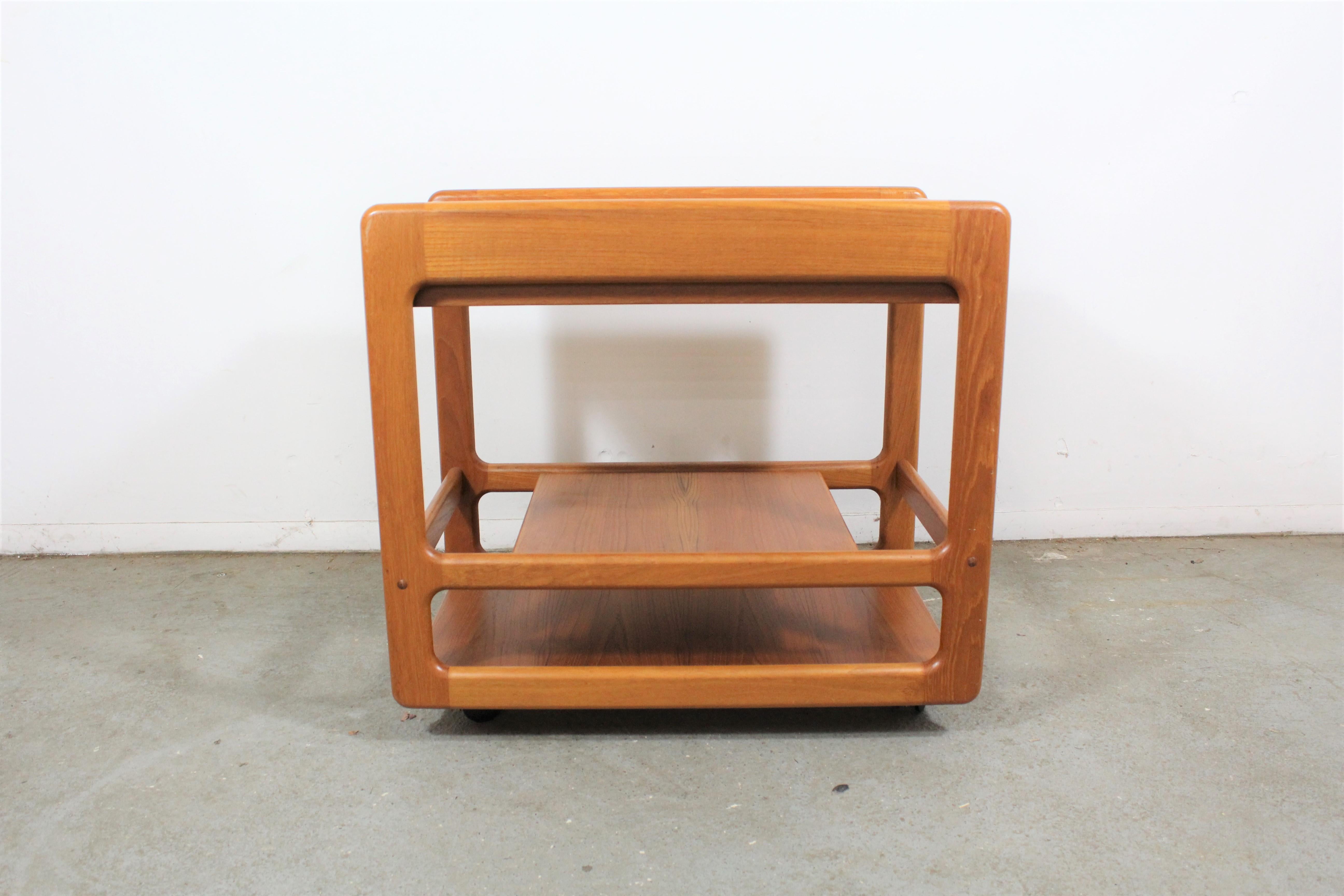 Danish Modern Teak Sliding Door Bar Cart

What a find. Offered is a vintage Danish modern bar cart on wheels. Features 2 bottom with compartments. Great for storage, serving drinks, or food. It is in very good vintage condition, showing some age