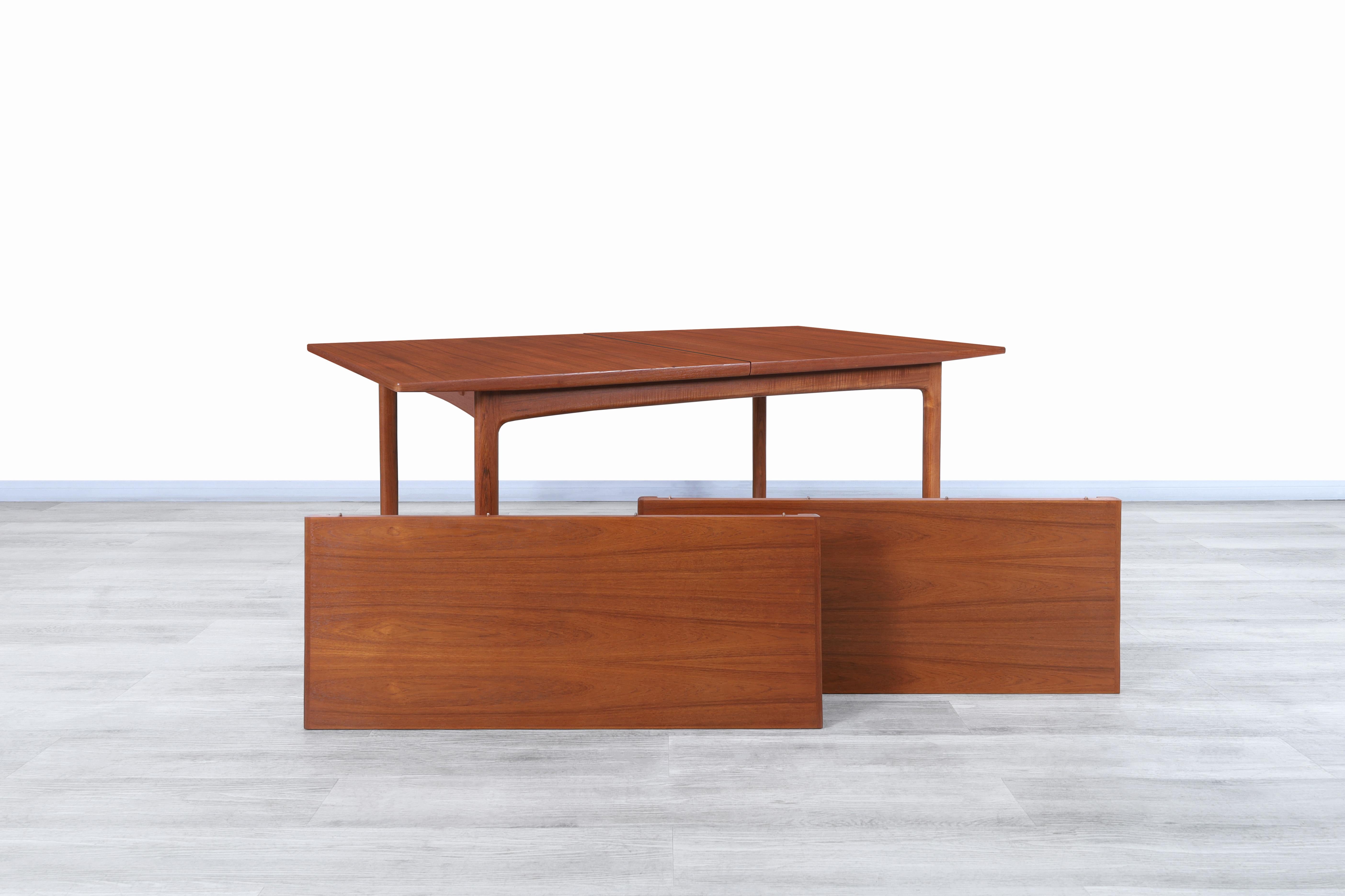 Fabulous mid century teak expanding dining table designed by Folke Ohlsson for DUX of Sweden, circa 1960s. This table has been made from the highest quality teak wood and features a distinctive design. This table stands out for its high