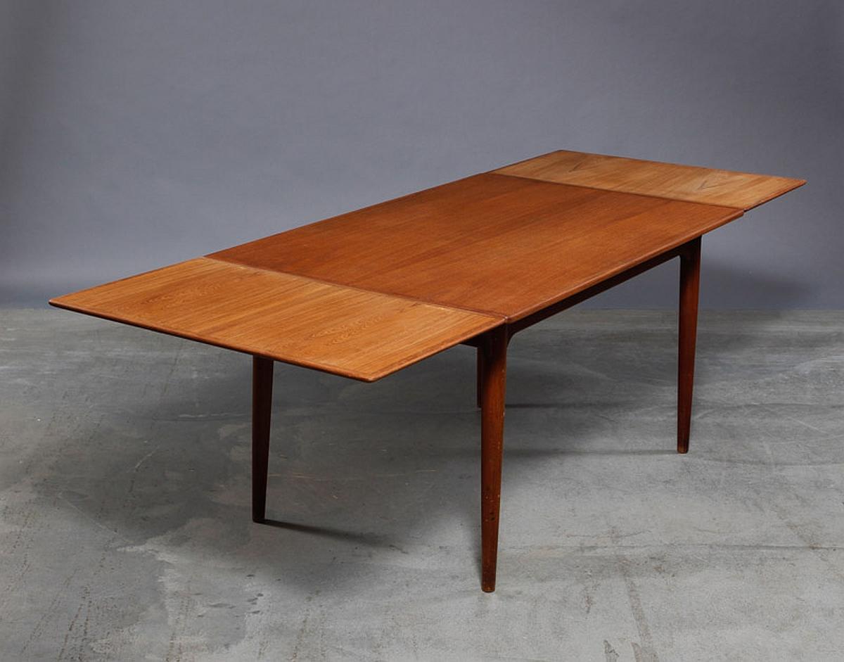 Danish modern teak extension dining table by Omann Jun. Expandable dining table of fine teak wood, rectangular plate with Dutch extract, 2 pull-out leaves, tapered legs, 1960s. Near perfect condition.