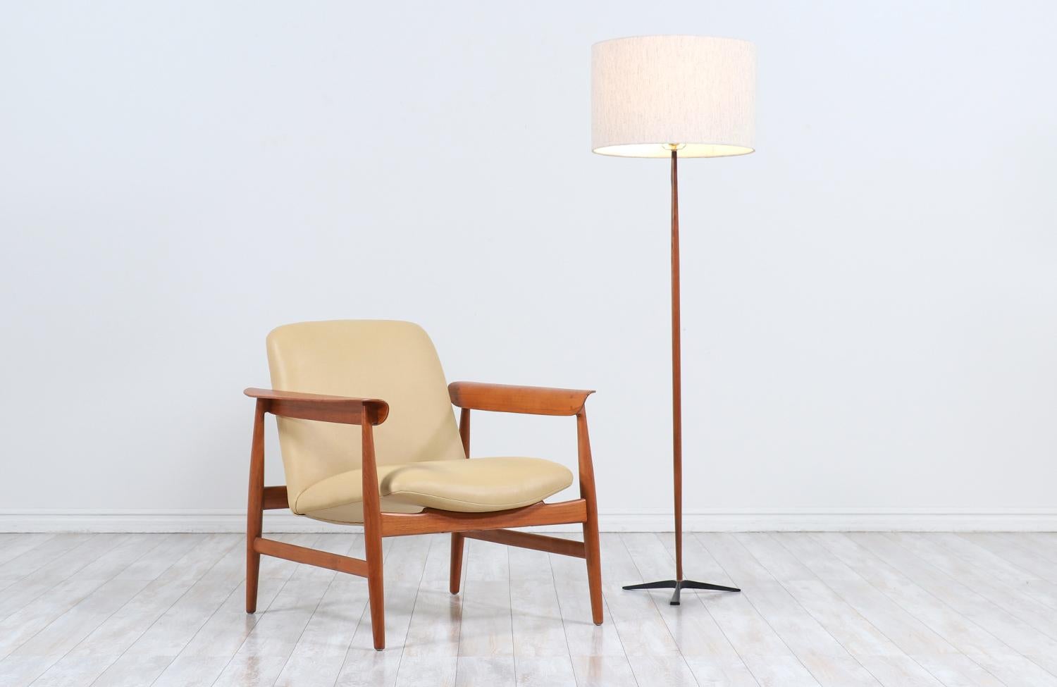 Danish Modern teak floor lamp with tripod Iron base.