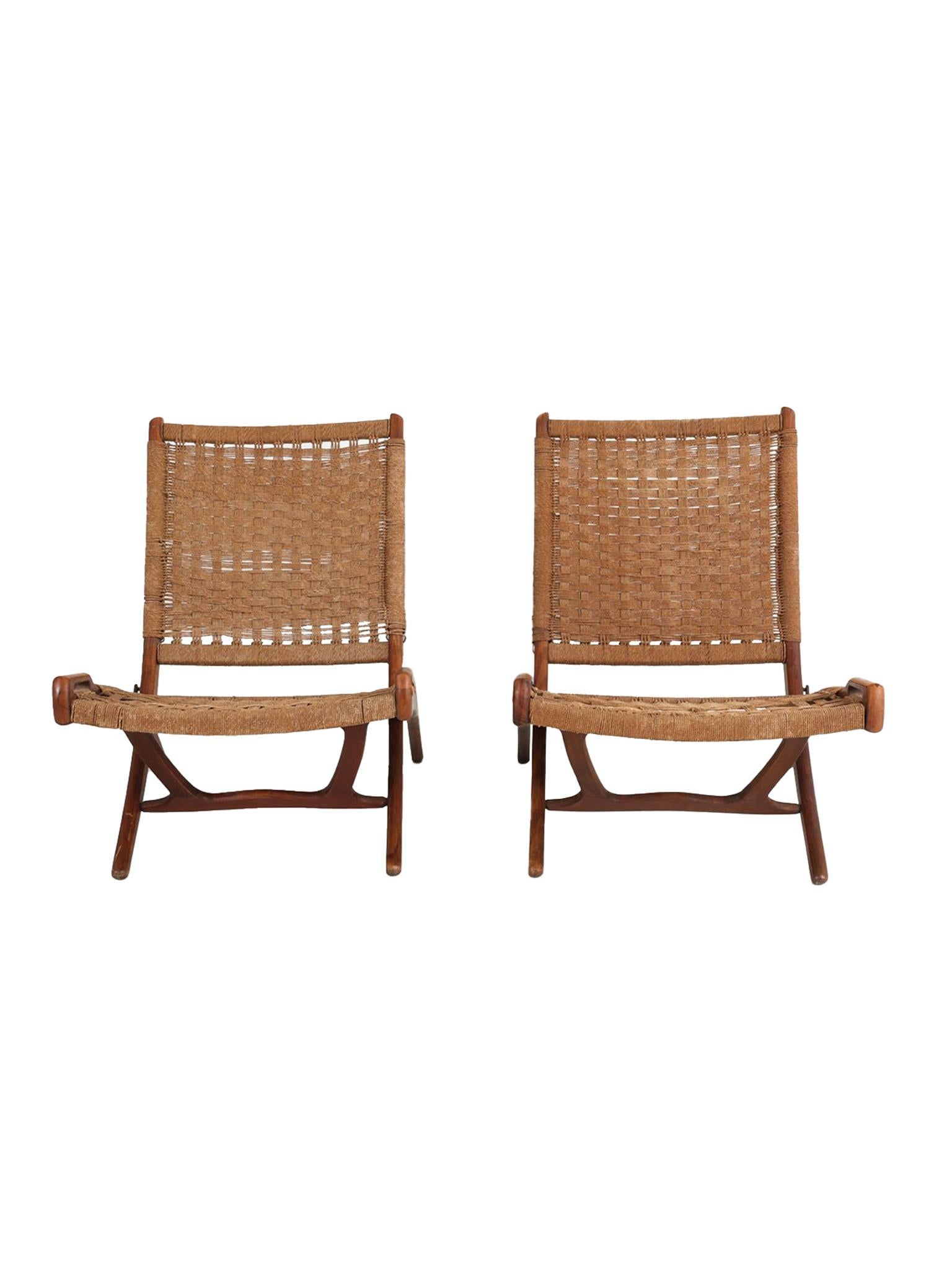 These Danish folding lounge chairs consist of teak frames with braided rope seating and back. A mixture of sleek, modern lines and handmade craftsmanship characterize the chairs' design. Similar to the folding chairs by Ebert Wels, they were