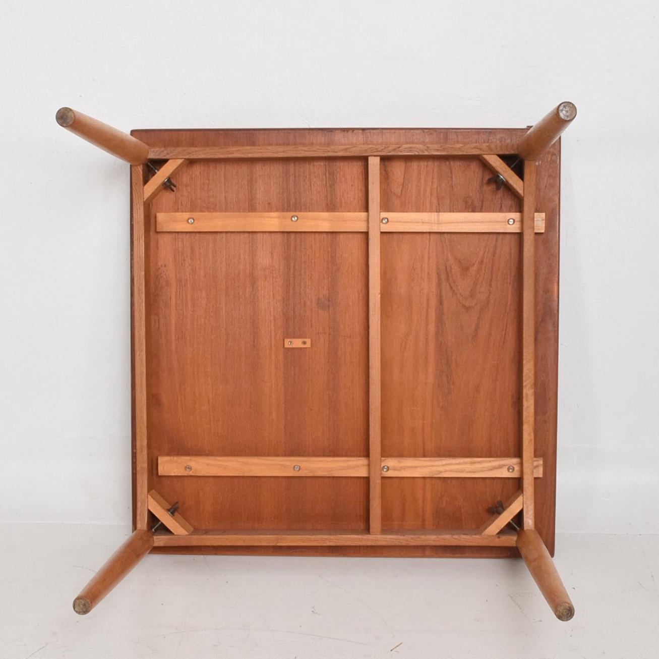 For your consideration a vintage Danish modern teak dining table with brass hardware.
Tapered legs in solid teak wood cab be removed for safe and easy shipping. Very clever design with folding top that allowing extending the top. It can seat from