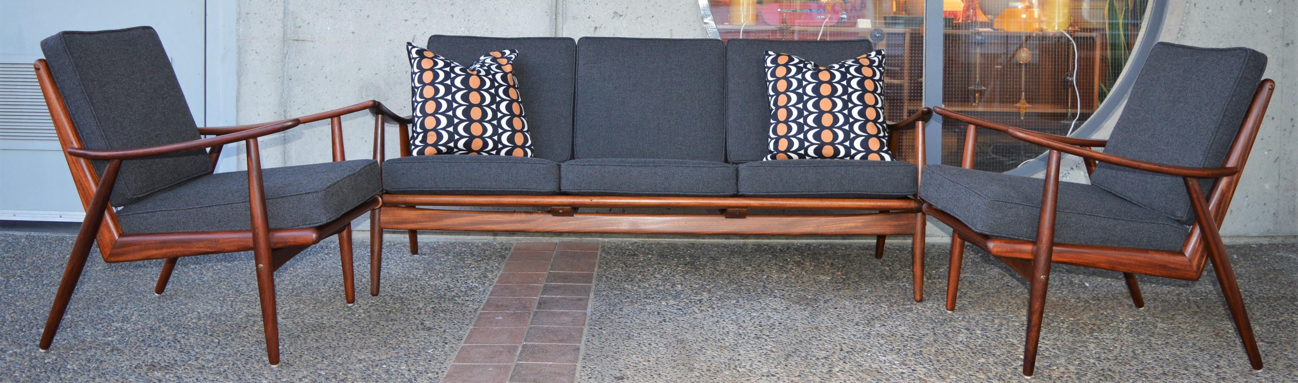 This killer restored Danish modern sofa and lounge chairs are spectacular - and so hard to have a complete set! Made entirely of solid Afromesian Teak, note the dramatic boomerang shape framing the sides of each seat, much in the style of Peter