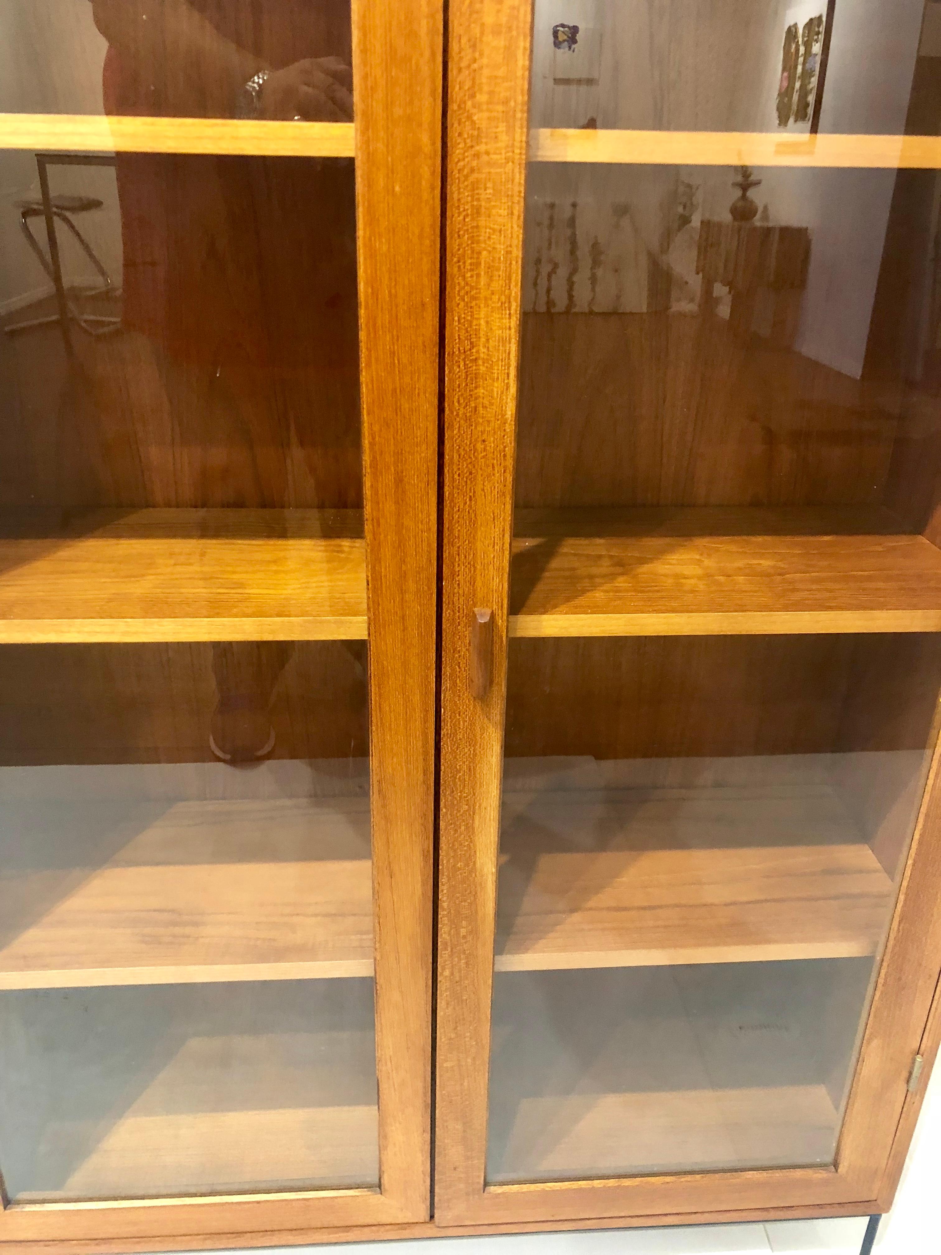 Danish Modern Teak Glass Bookcase by Dyrlund on Solid Iron Base In Excellent Condition In San Diego, CA