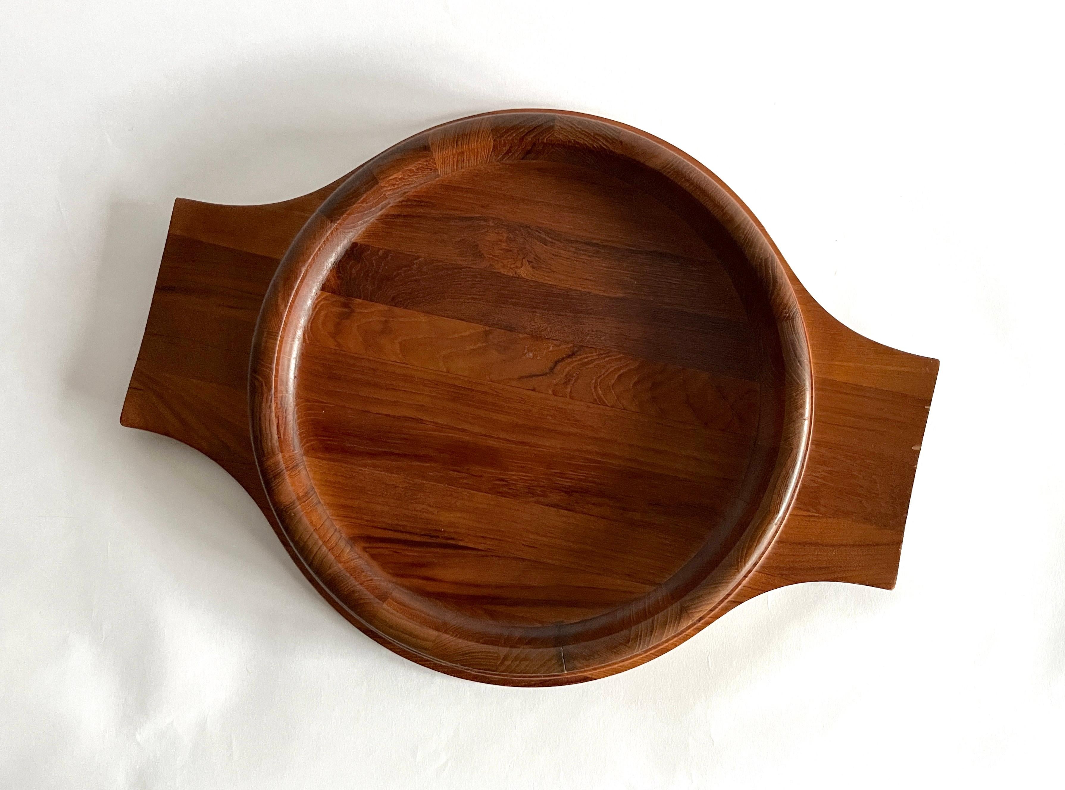 A truly hard-to-find matched set of Dansk Danish modern teak bowl and tray serveware designed by Jens Quistgaard. A very large handled serving tray is accompanied by a shallow serving bowl. The tray was made in Denmark and the bowl was made in
