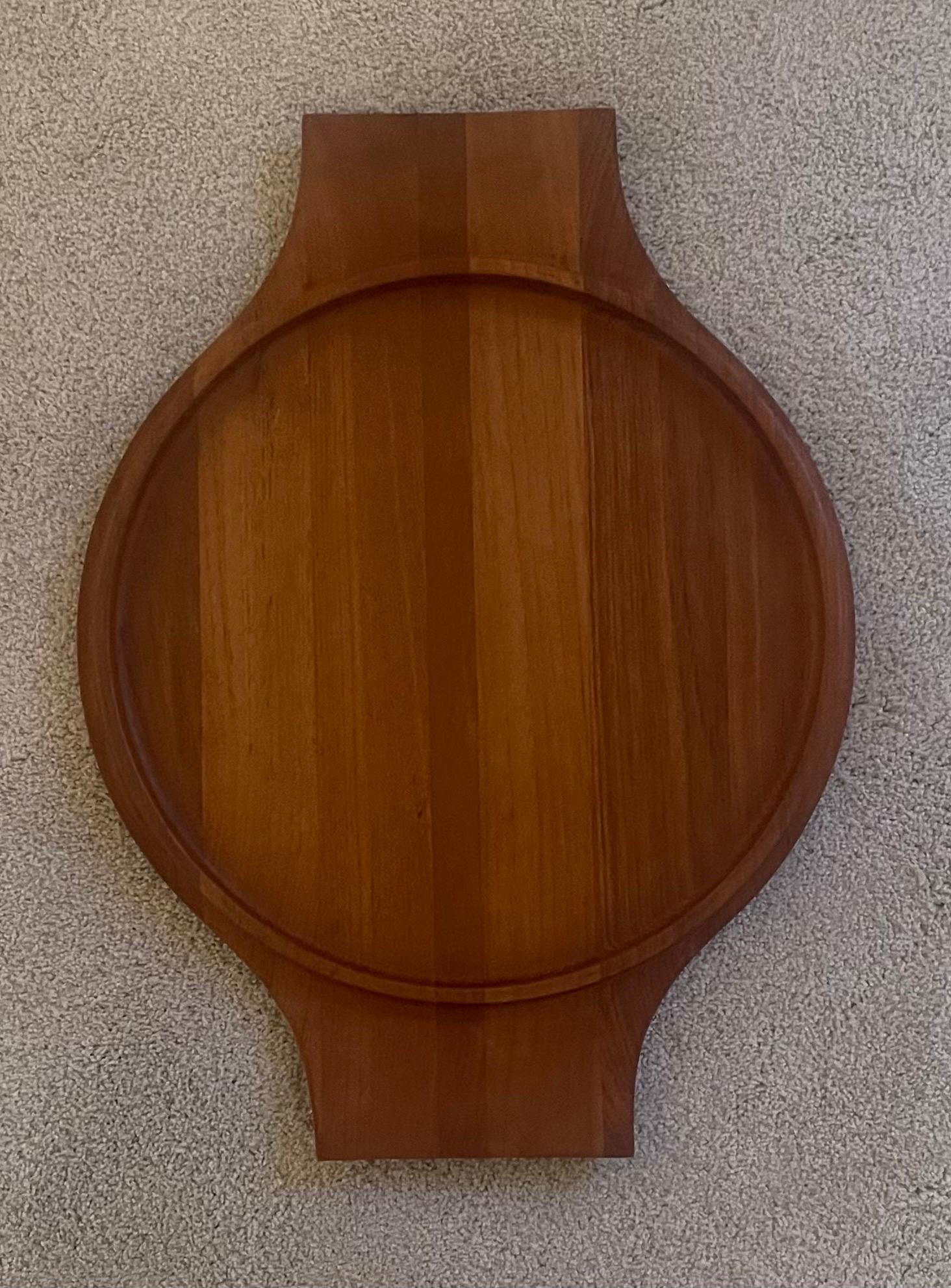 A very hard to find Danish modern teak handled serving tray by Jens Quistgaard for Dansk, circa 1960s. The piece is in very good vintage condition and measures 21.5