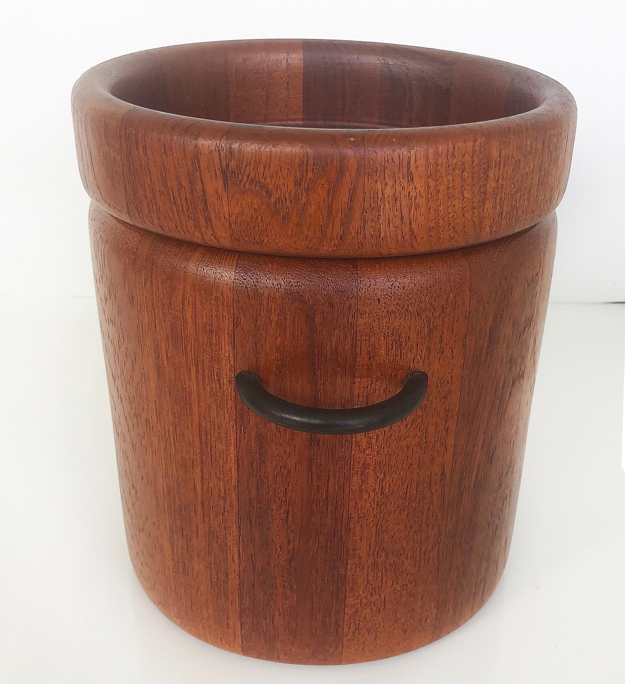 Danish Mid-Century Modern teak ice bucket by Digsmed Design

Offered for sale is a Danish Mid-Century Modern teak ice bucket by Digsmed Design of Denmark. It has the original plastic interior liner and retains the manufacturer's label on the