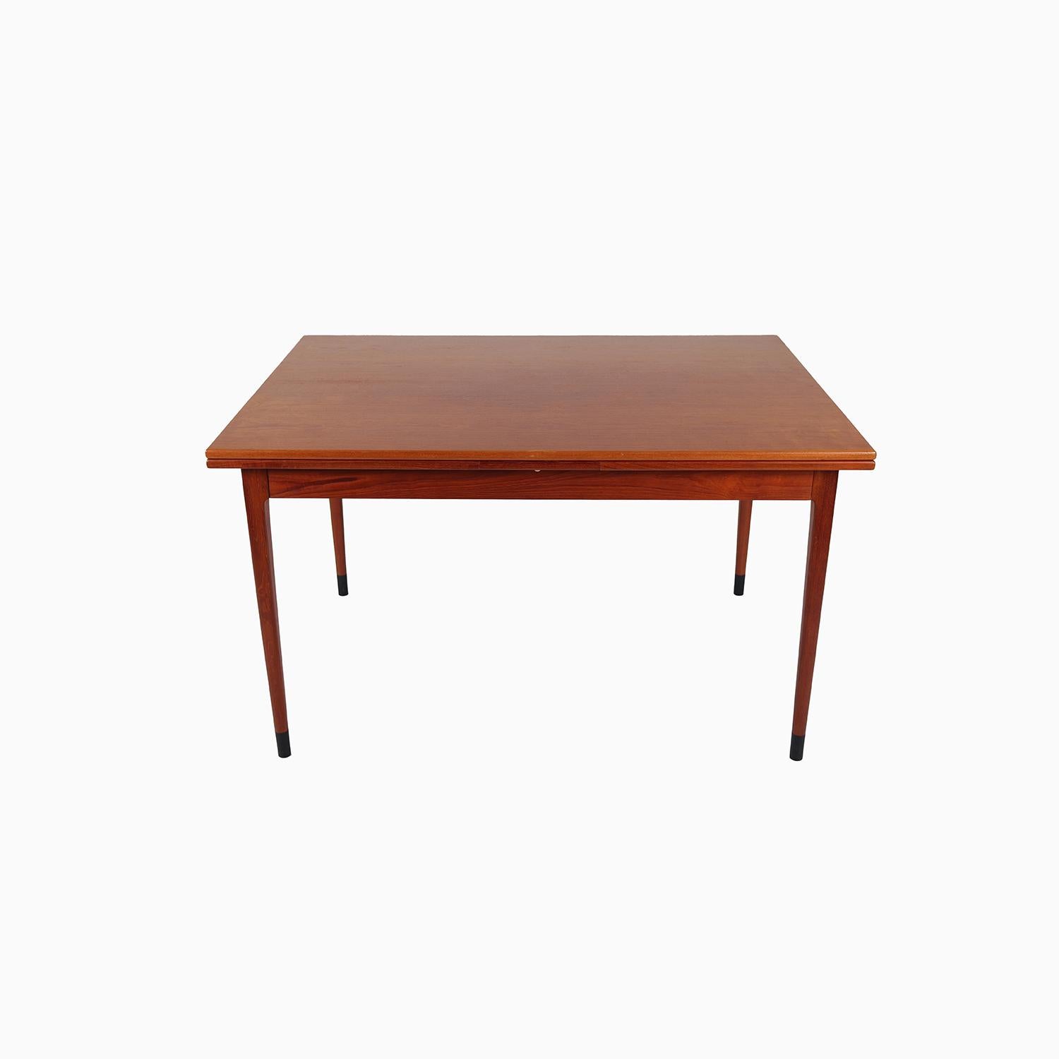 A Danish Modern dining table by the well known Danish manufacturer J.L Møller. Design by N.Ø Møller. Teak with black capped feet. 

Professional, skilled furniture restoration is an integral part of what we do every day. Our goal is to provide