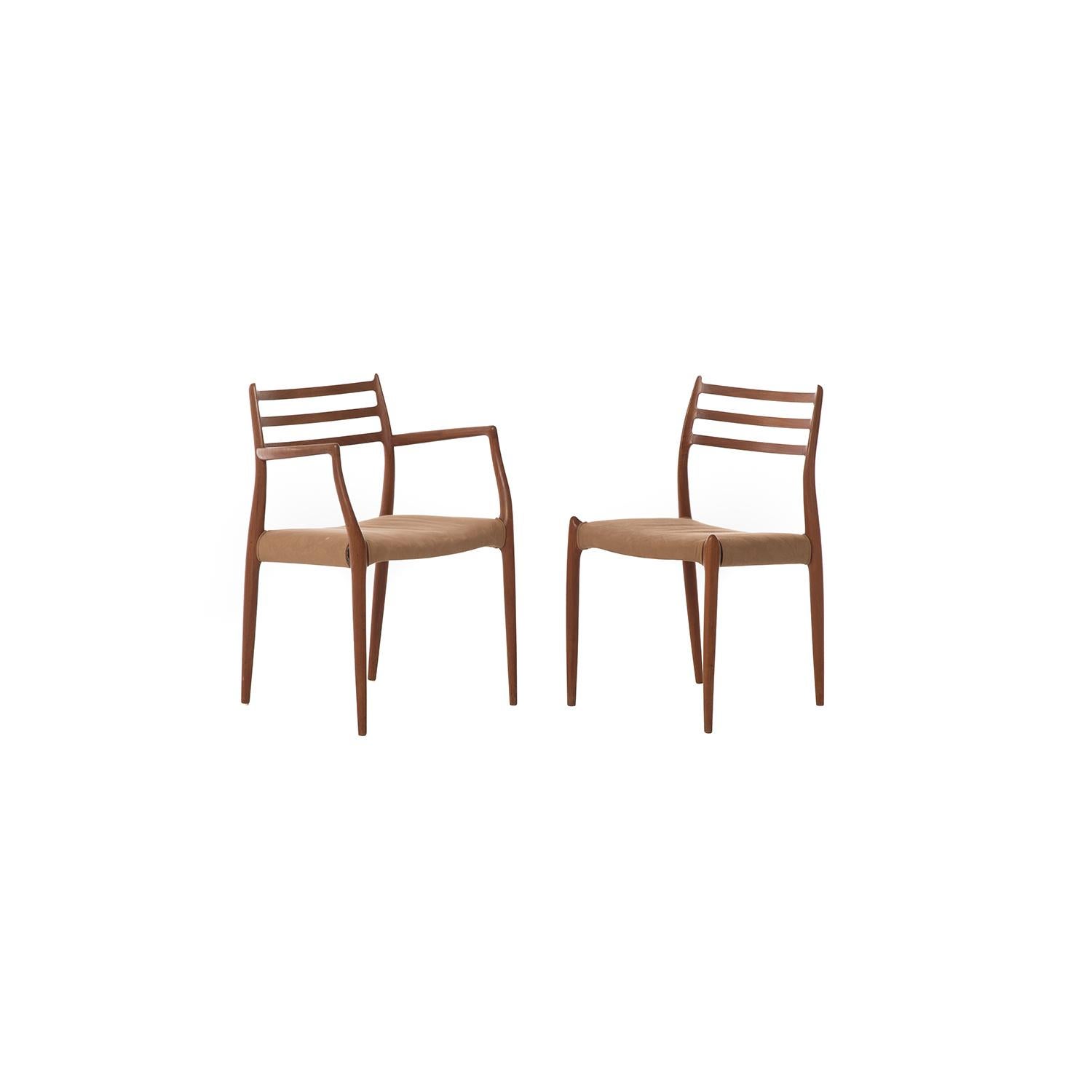 Set of eight elegant ladder-back dining chairs by Niels Otto Møller. Includes two armchairs. This Classic set of chairs is made from solid wood old growth teak with an oil finish. Frames have been restored, seats need new upholstery and webbing.

 