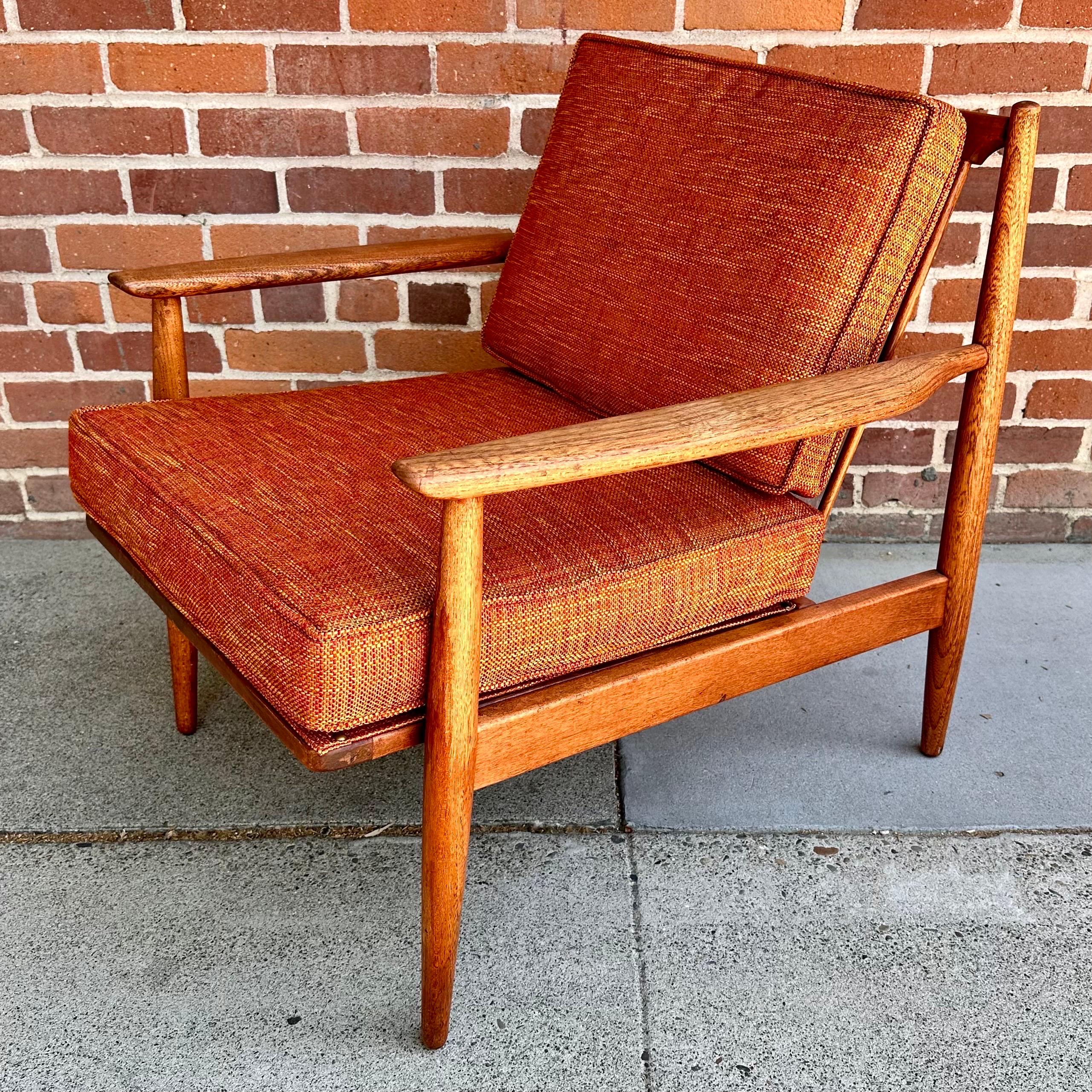 1960s Danish Modern teak lounge chair, professionally reupholstered with new foam and orange fabric. The chair is in good vintage condition, with light wear consistent with age and use. 

Width: 27.5 in / Depth: 30 in / Height: 29.25 in / Seat