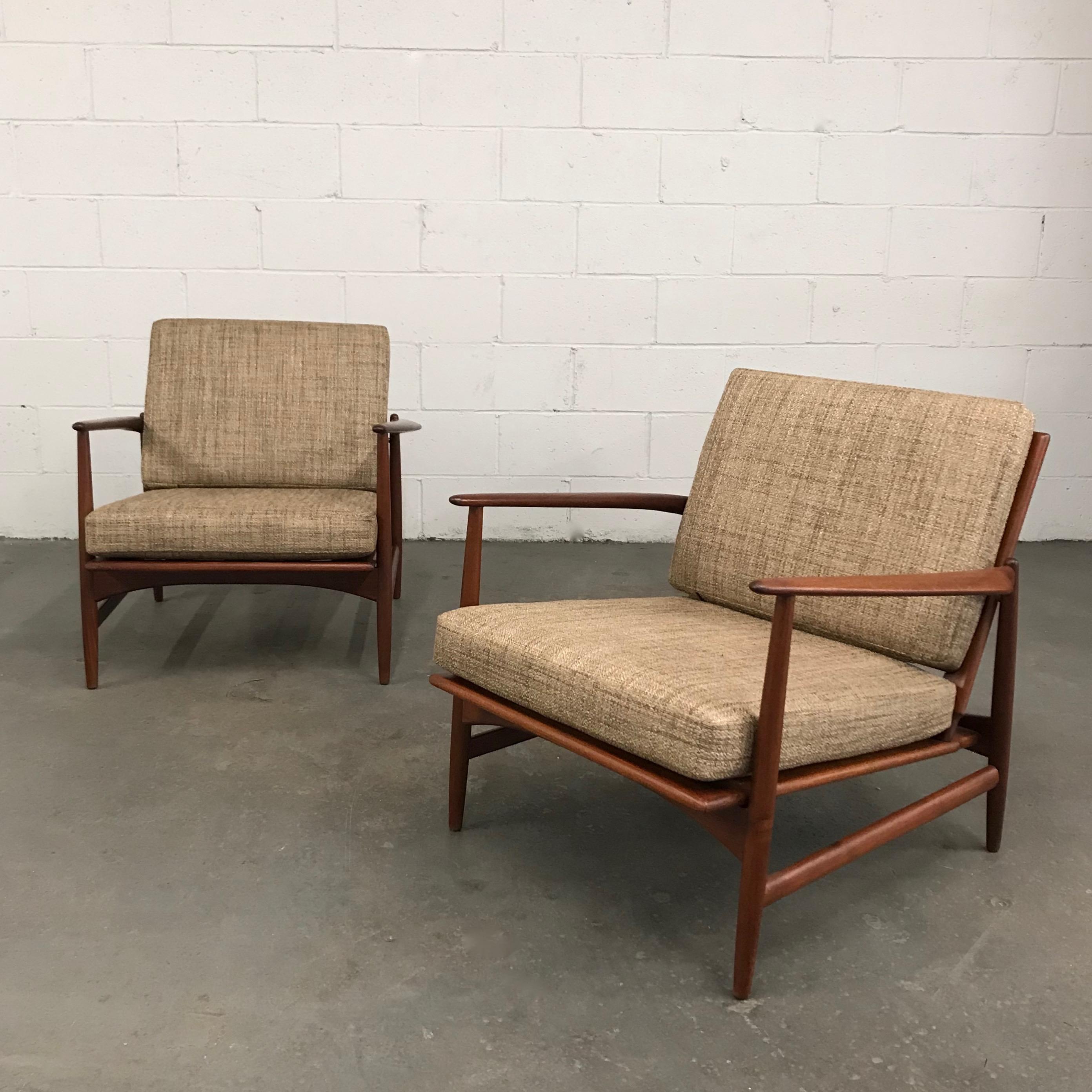 Pair of Danish modern, lounge chairs by Ib Kofod Larsen for Selig feature beautifully detailed, teak frames with linen blend, tweed cushions.