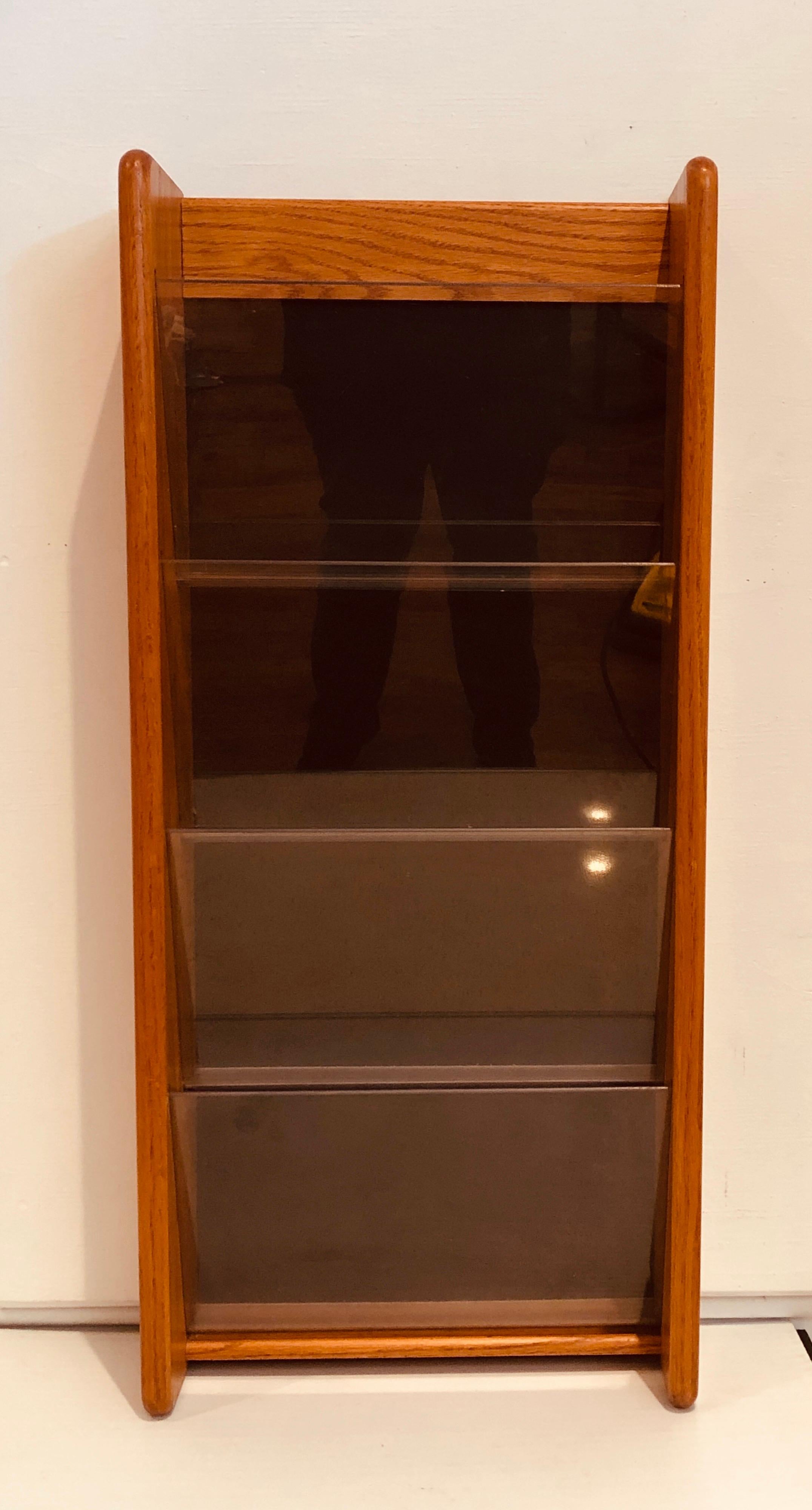 Versatile wall-mounted magazine Holder, with 4 pockets of acrylic solid teak walls easy to hang nice condition circa 1980's we have 2 available , the buyer has the choice to buy 1 or 2.