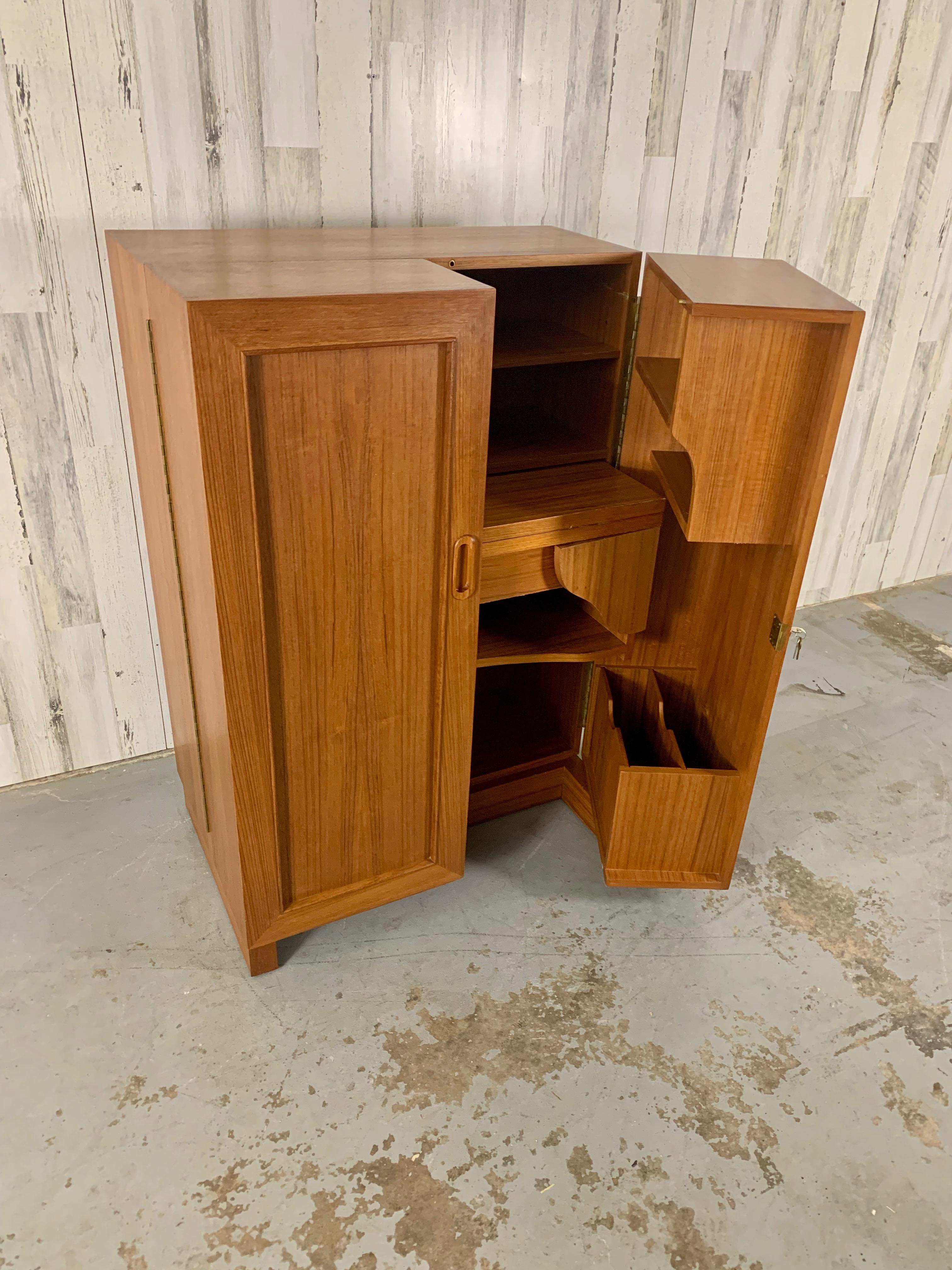 Convertible cabinet that opens to a large desk with multiple cubby’s and file storage. There are two keys for the door and drawer.