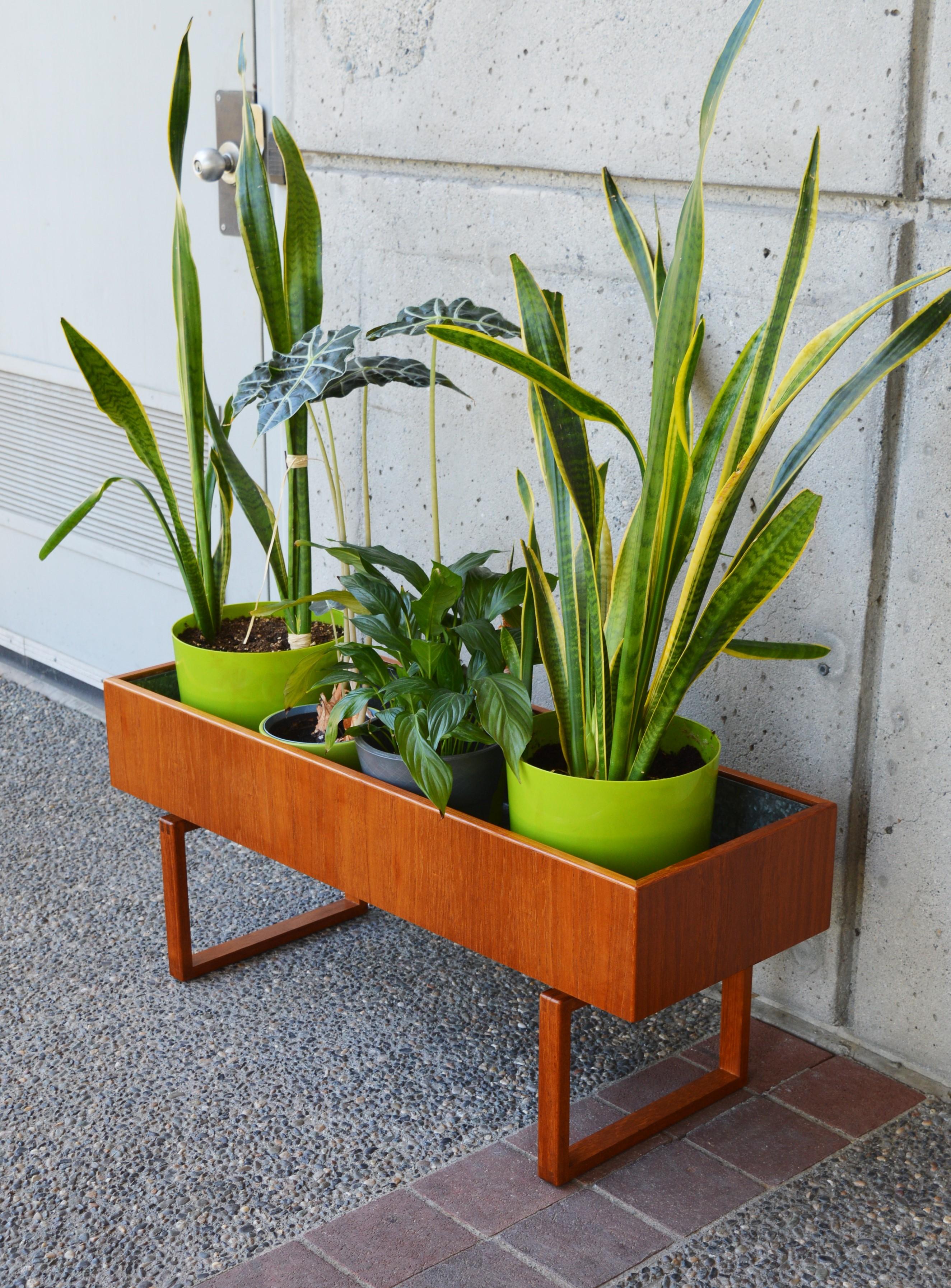 This striking Minimalist planter box was designed by Kai Kristiansen for Salin Mobler in the 1960s. The cubic base with finger jointed corners supports the generous planter box. The grain is lovely, and the unit is in amazing vintage condition -