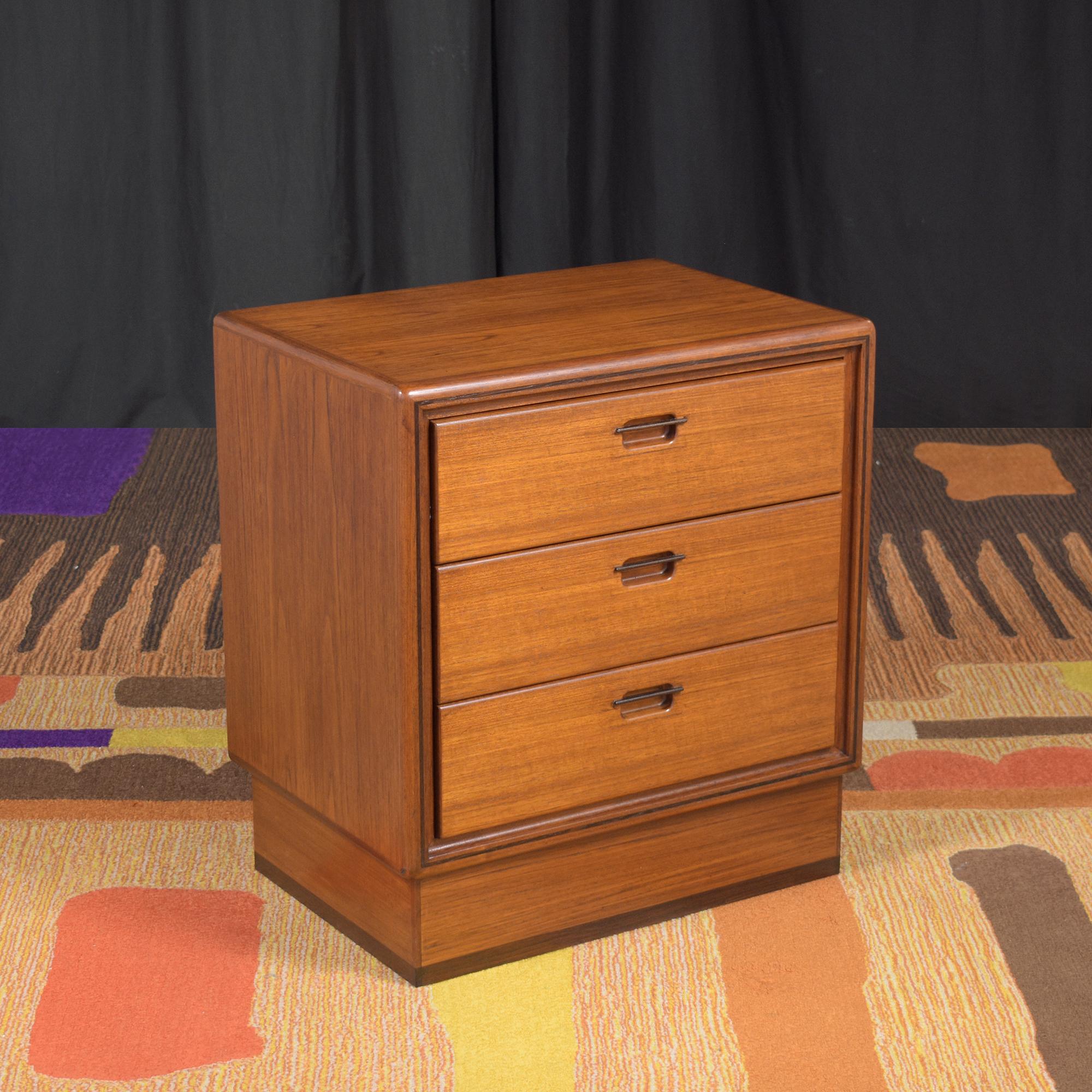 Immerse yourself in the timeless beauty of Danish design with our exquisitely restored 1960s Danish Modern Single Nightstand. This piece, handcrafted from premium teak wood, epitomizes the iconic mid-century design ethos, blending form and function