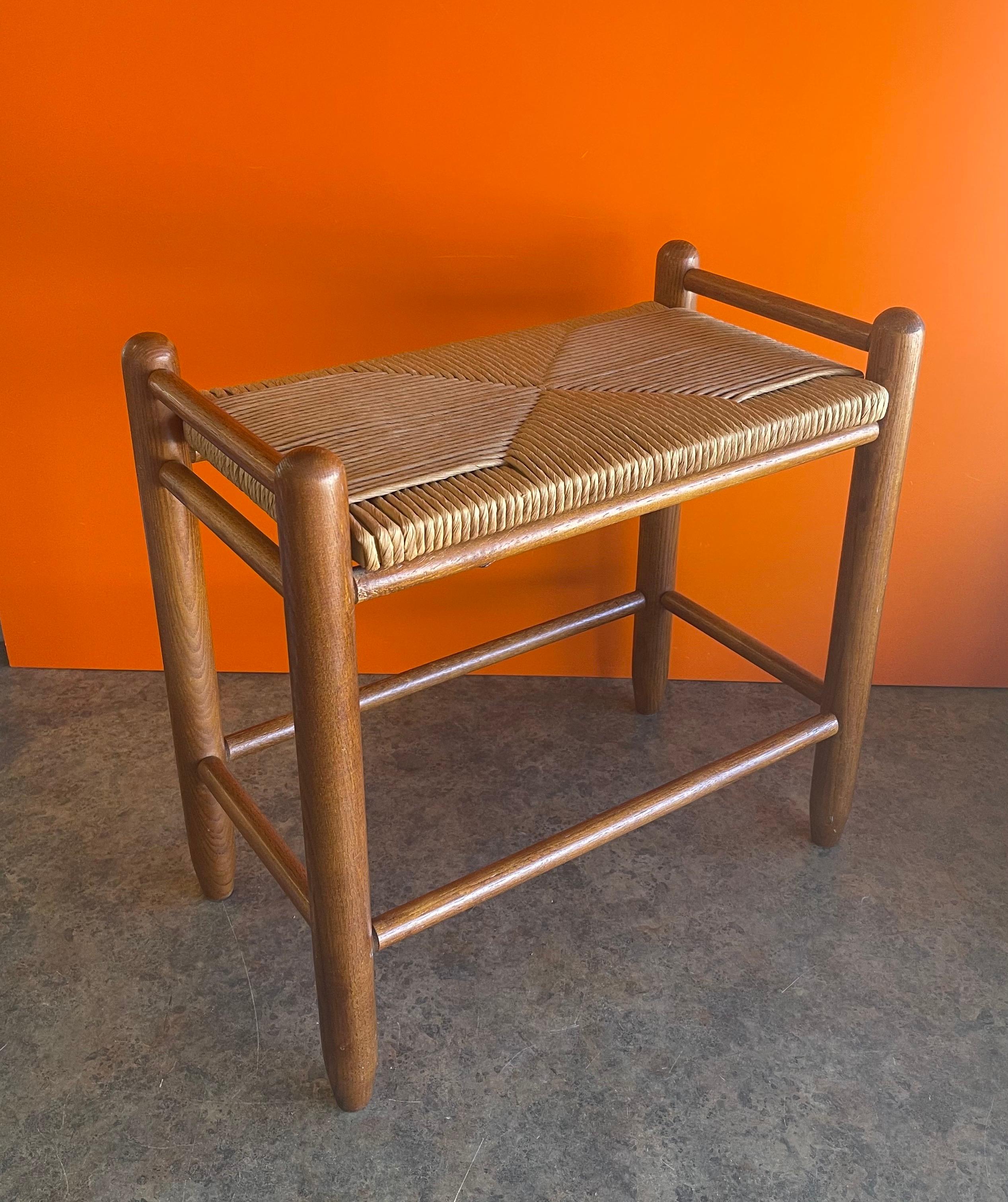 Versatile Danish modern stool / bench with hand woven paper cord seat, circa 1970s. The piece has a solid teak frame with stretchers and is quite solid and sturdy. The bases measures: 21