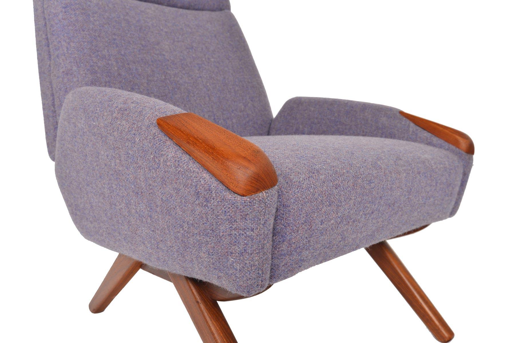 This Danish modern high back lounge chair features teak paws and a provocative canted leg base. Its tall, structural back not only creates a beautiful profile but offers back support and ergonomic comfortability. Chair wears a soft lavender wool