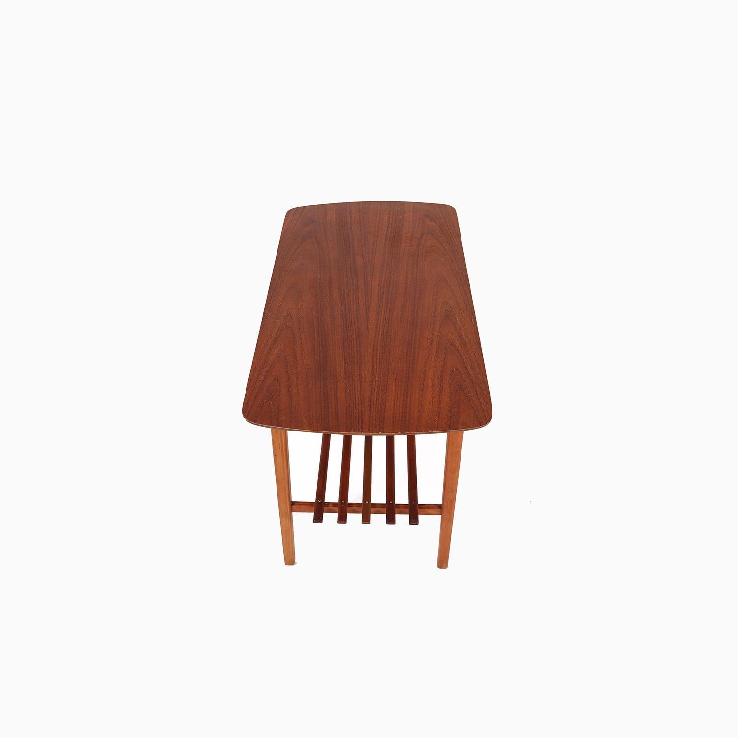 An interesting Danish Modern occasional table made from teak and pine. A design that features the newer methods of the period by using an exposed beveled ply top with an oiled teak veneer. Base is constructed using pine that gives the table visual