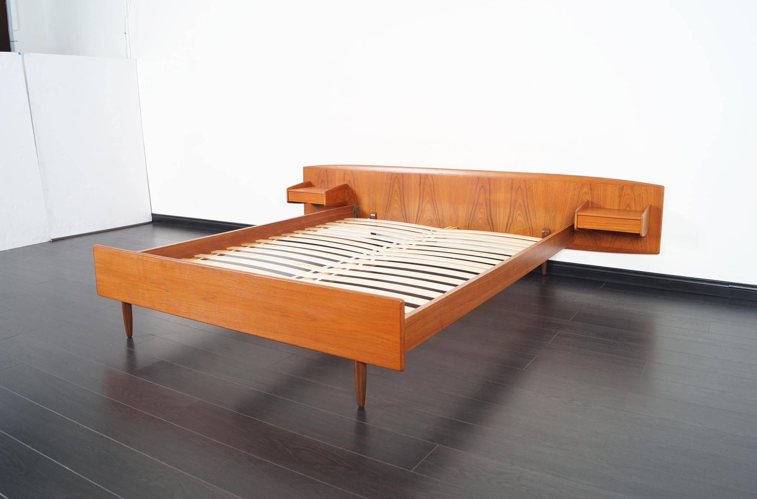 An incredible Danish modern teak queen bed designed by Melvin Mikkelsen for Melvin Mikkelsen Møbler, Pandrup, Denmark. Features a pair of floating nightstands, each with a single dovetailed drawer.