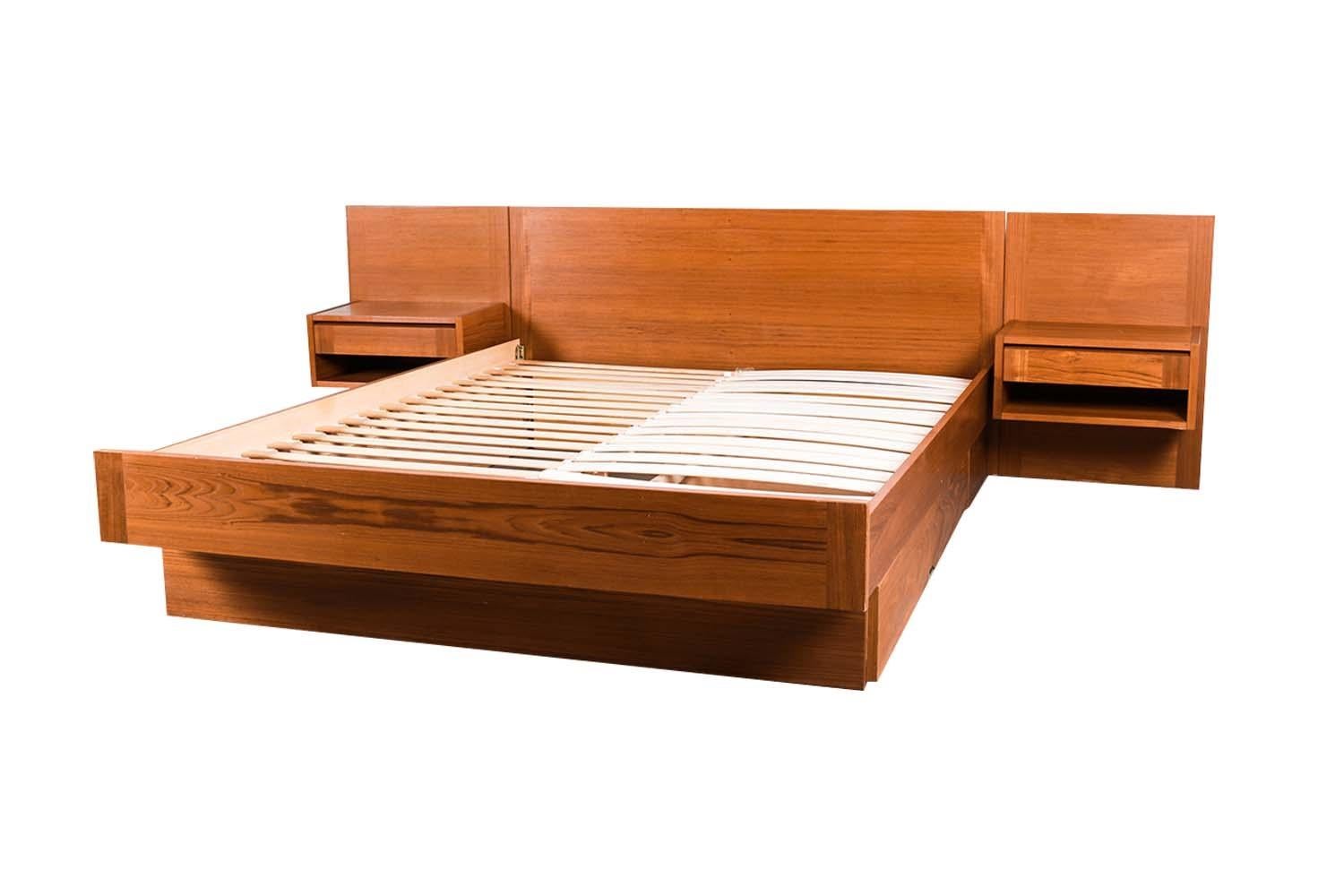 A remarkable Danish teak, mid-century queen floating platform bed with floating nightstands and a storage drawer, made in Denmark. Exceptional construction and style. Featuring a stunning headboard with hanging, floating, nightstands, both with a