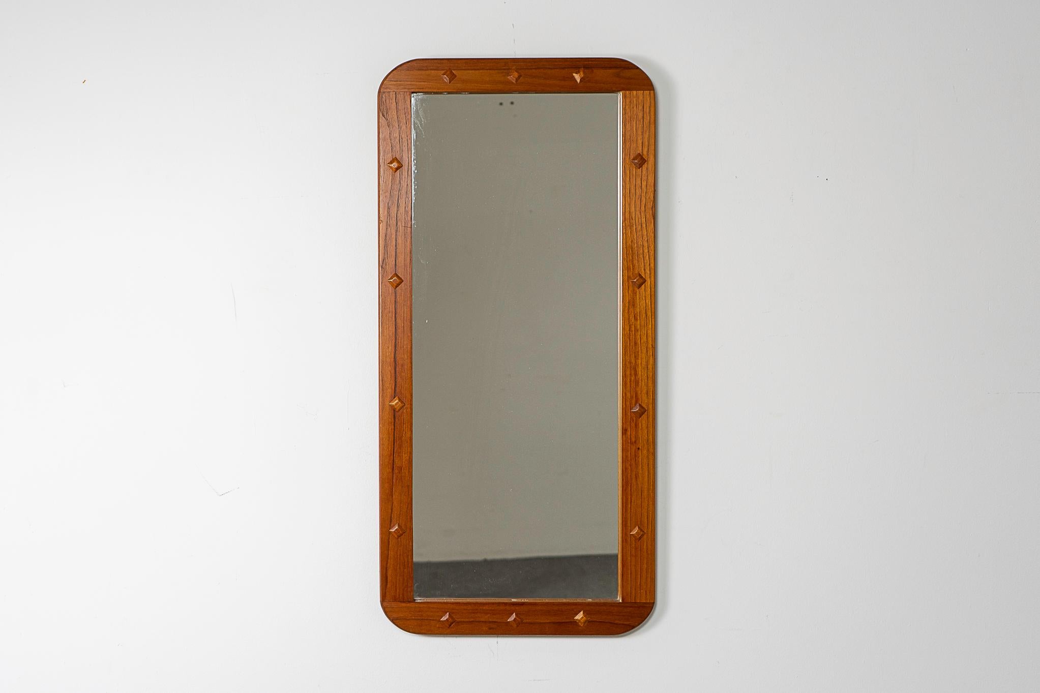 Teak mid-century mirror, circa 1960's. Solid wood frame with stunning grain and diamond relief details. Glass is in nice condtion.

Please inquire for remote and international shipping rates.
