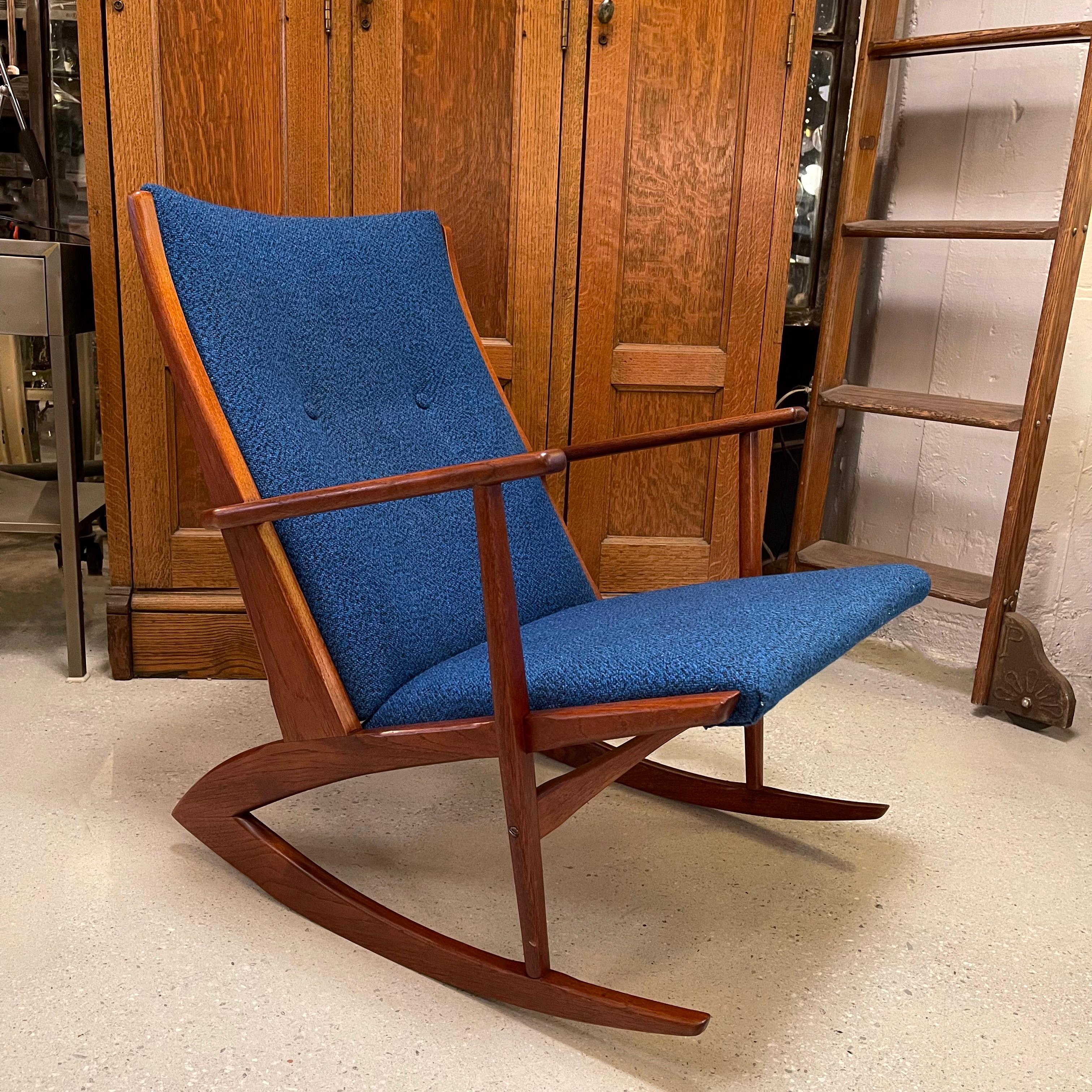 Danish modern, model 97, rocking chair by Holger Georg Jensen for Tønder Møbelværk upholstered in deep blue wool blend to contrast the sculptural, teak frame.
