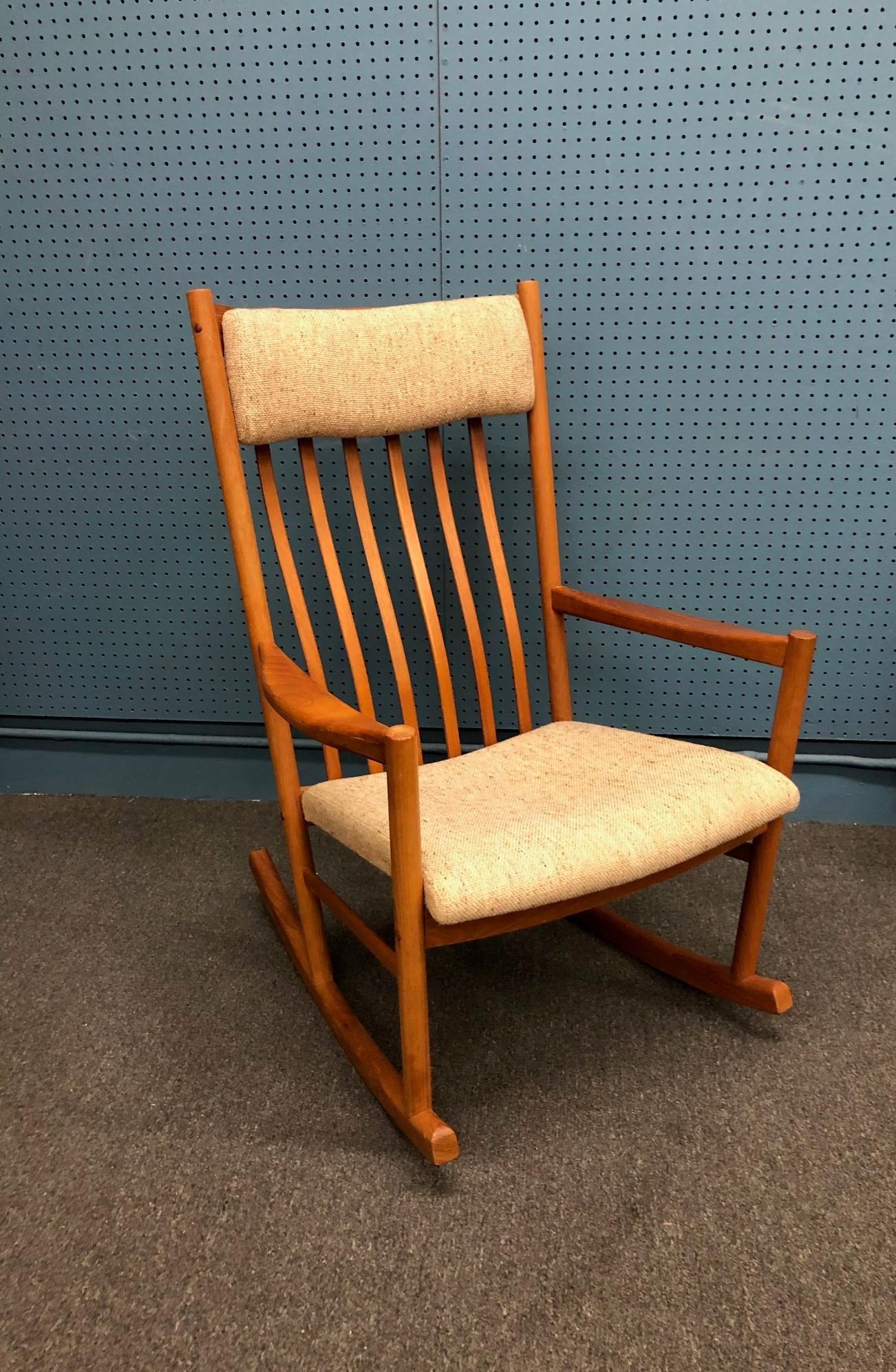 Danish modern solid teak rocking chair/rocker.
This rocking chair is even more impressive in person. The over sized proportions of this design make a statement but it does not overwhelm the room. The beautiful warm glow of the reddish teak is