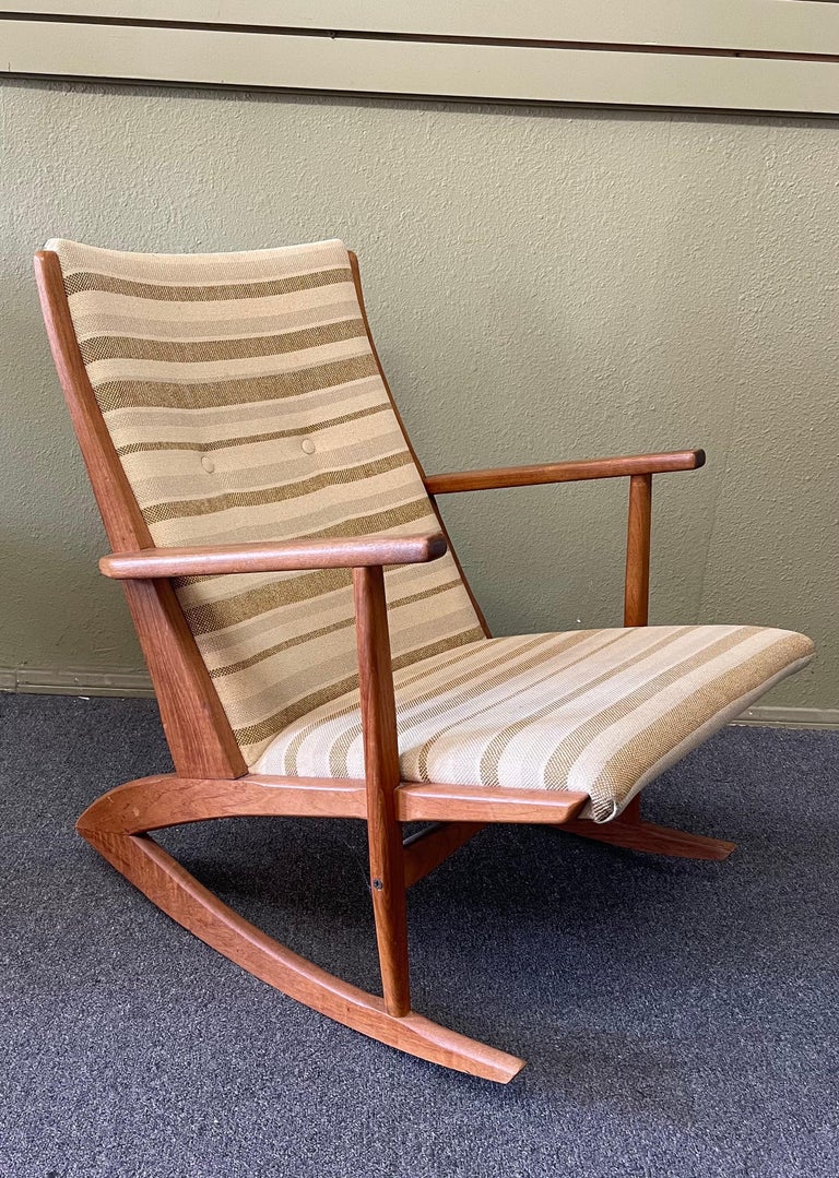 Wonderful pair of Danish modern teak rocking chairs by Holger Georg Jensen for Tonder Mobelvaerk, circa 1950s. The chairs have a striking Danish design with solid teak frames and original upholstery. They are in good condition with minor wear