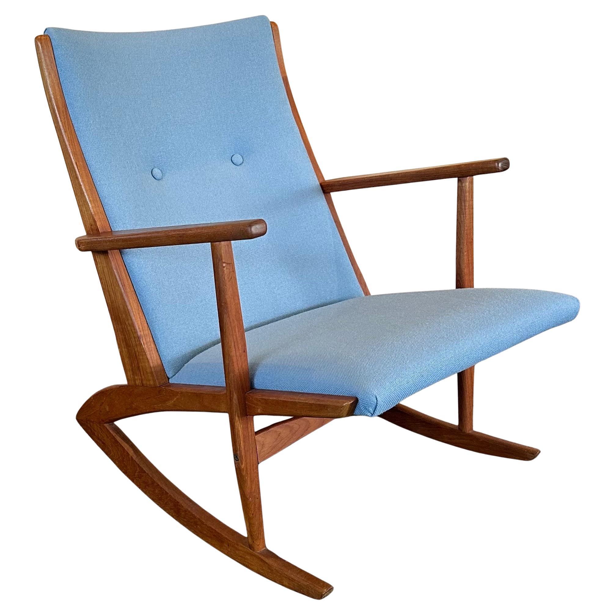 Wonderful Danish modern teak rocking chair by Holger Georg Jensen for Tonder Mobelvaerk, circa 1950s. The chair has a striking Danish design with solid teak frame and has been re-upholstered in a beautiful robin egg blue linen fabric.  The chair is