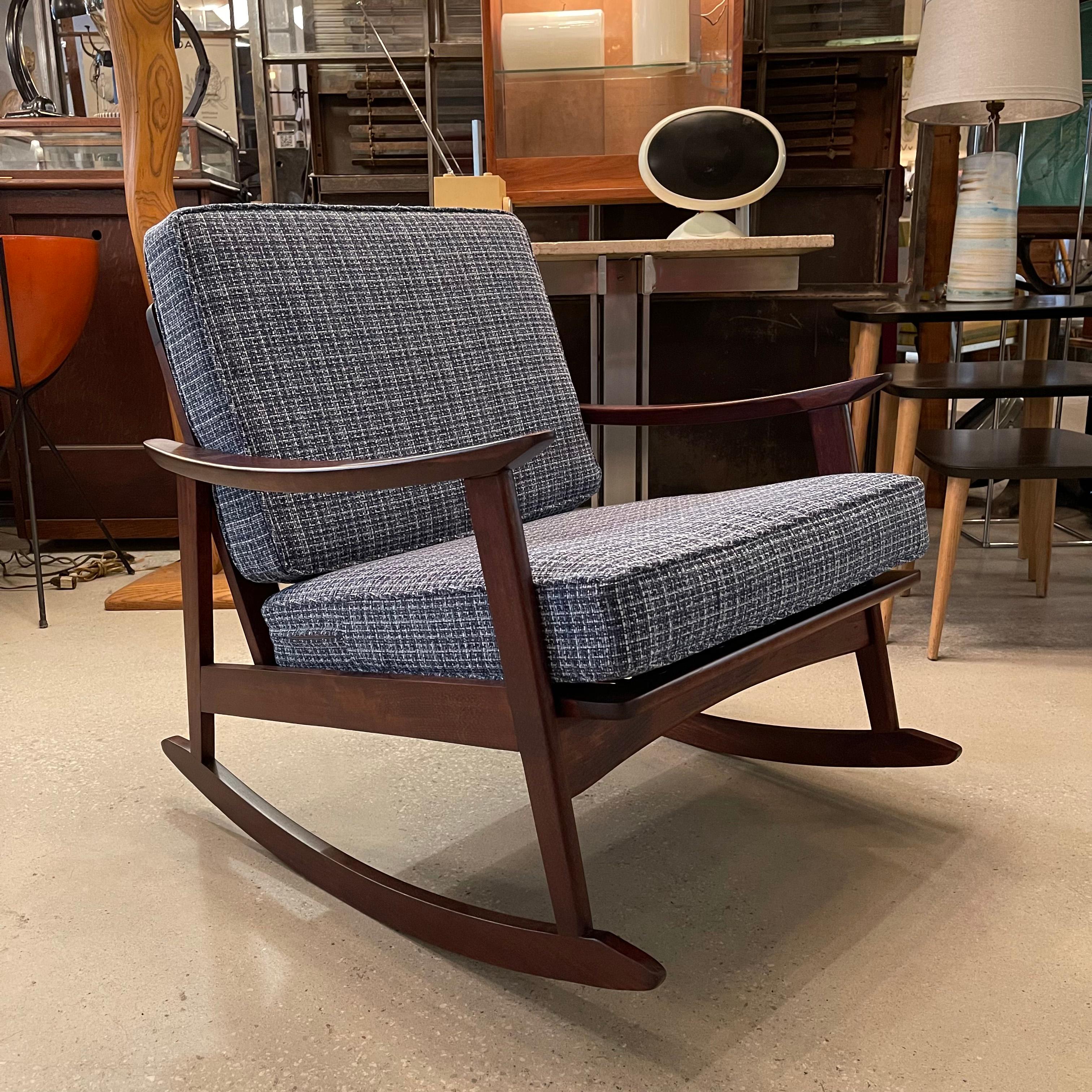 Danish modern rocking lounge chair features a sleek, teak frame with seat and back cushions upholstered in a cozy blue chenille tweed.