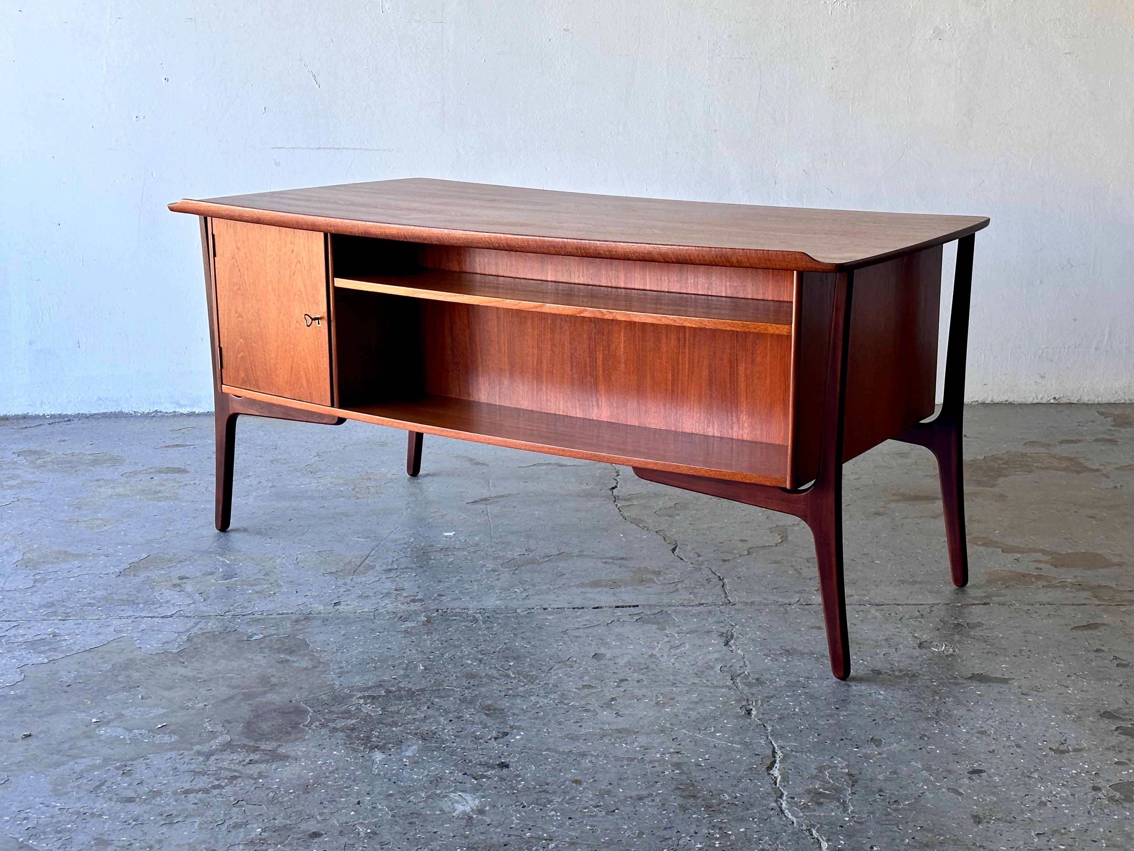 
Danish Modern Teak & Rosewood Desk by Svend Madsen
         
    Absolutely stunning vintage Danish teak and rosewood  desk  by Danish designer Svend Madsen. for H.P Hansen. The desk features a gorgeously curved desktop with beautiful lip detail on