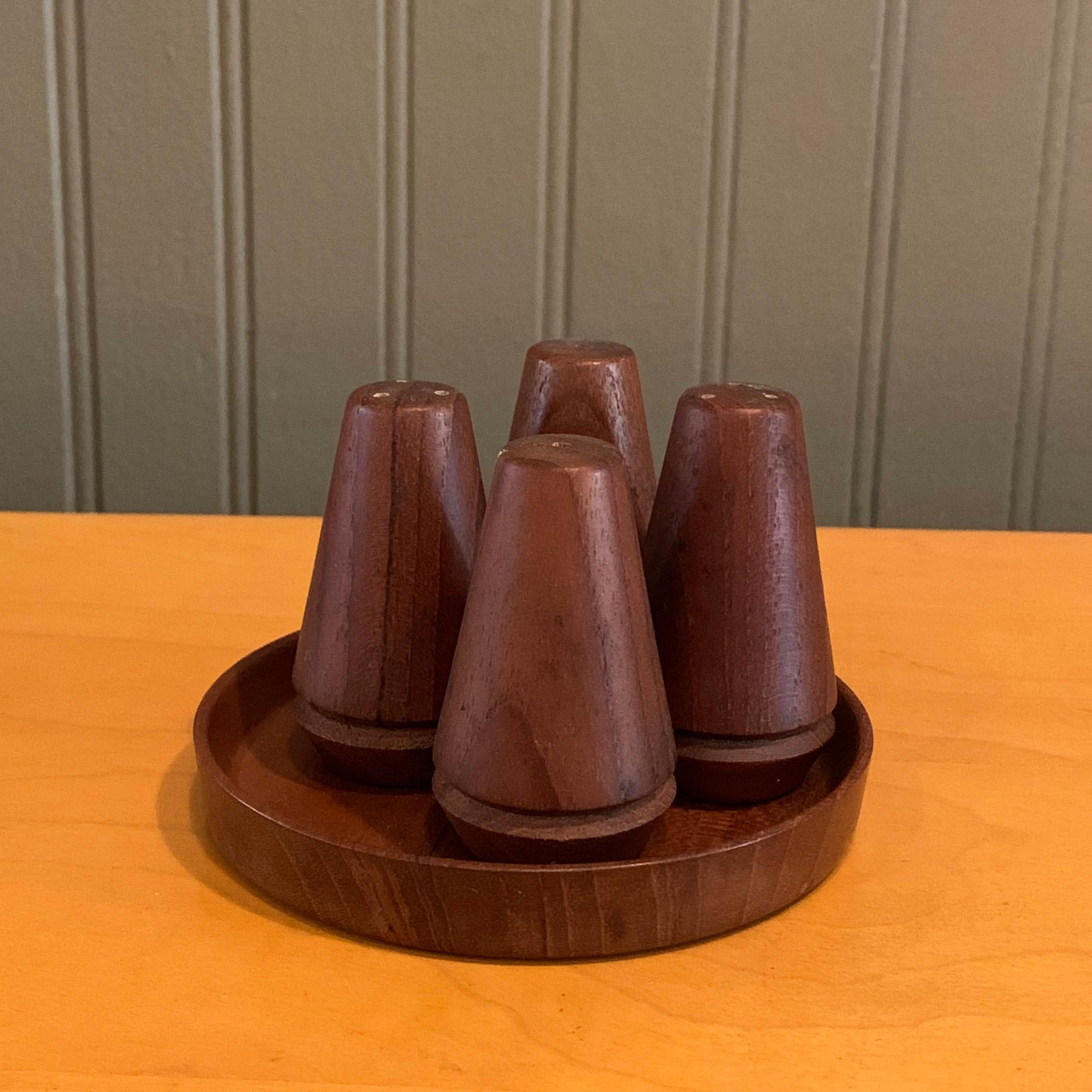 Danish modern, teak, salt and pepper shakers set by Ludvig Pontoppidan features 2 sets of shakers in a round holding tray.