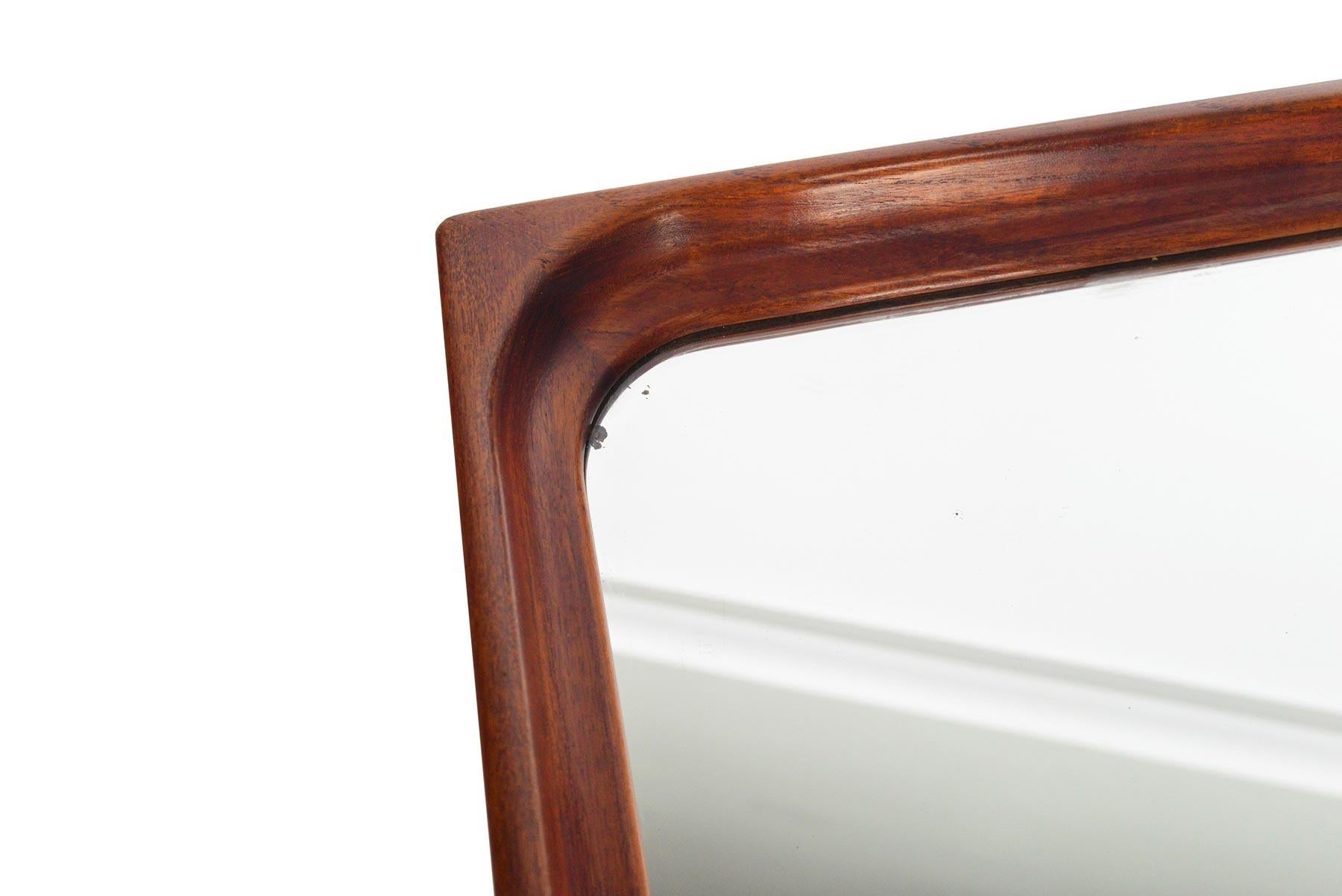 This Danish modern midcentury teak framed wall mirror is the perfect accessory for any modern home. A solid teak frame is showcased by a beautifully sculpted interior edge, providing depth to this silhouette. In excellent condition.

 