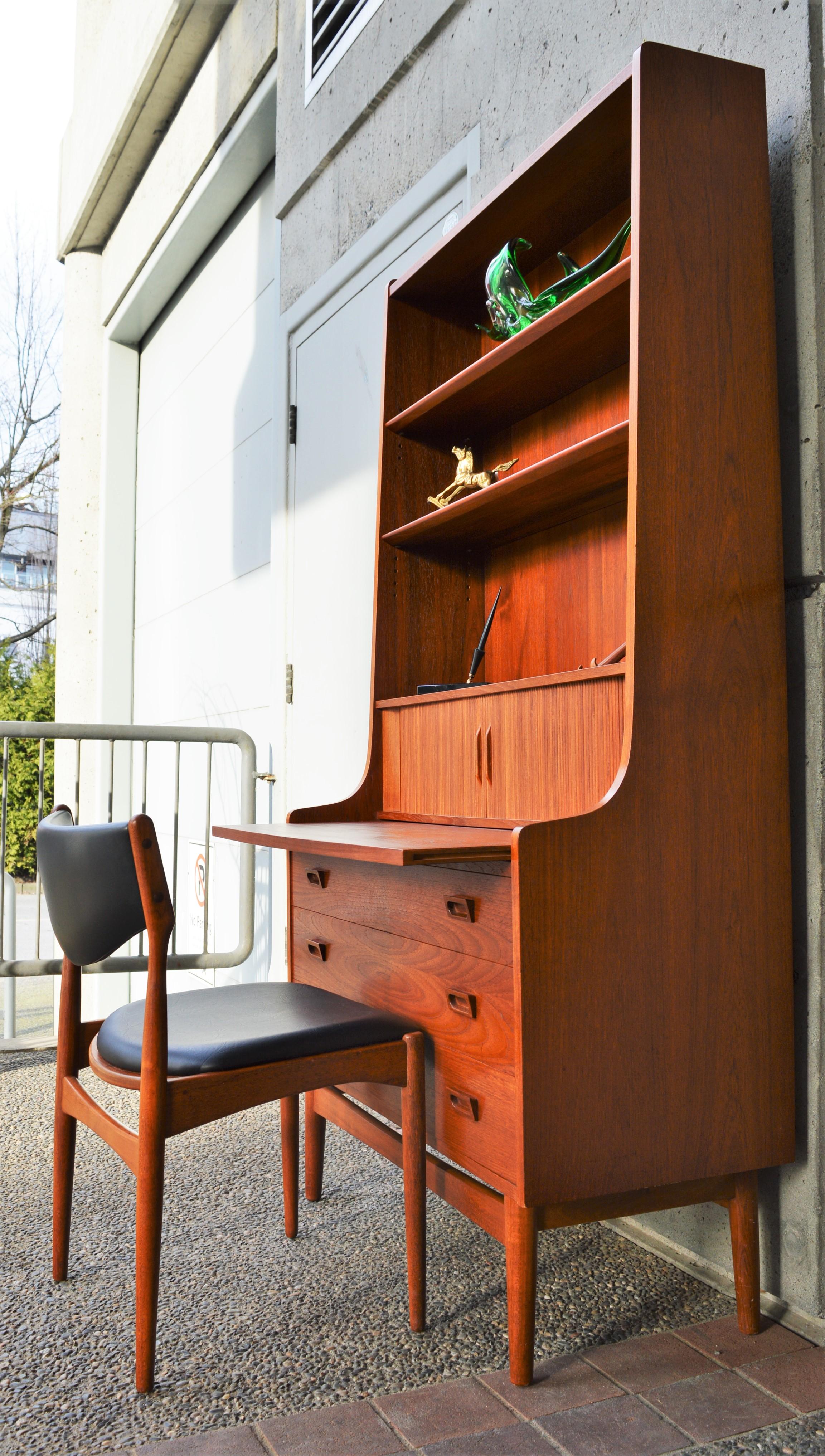 This impeccable Danish modern teak secretary is a quality construction designed by Johannes Sorth for Bornholm Mobelfabrik in the 1960s. Made of teak veneer with all hardwood construction, it has so many handy design features! Firstly, the handy