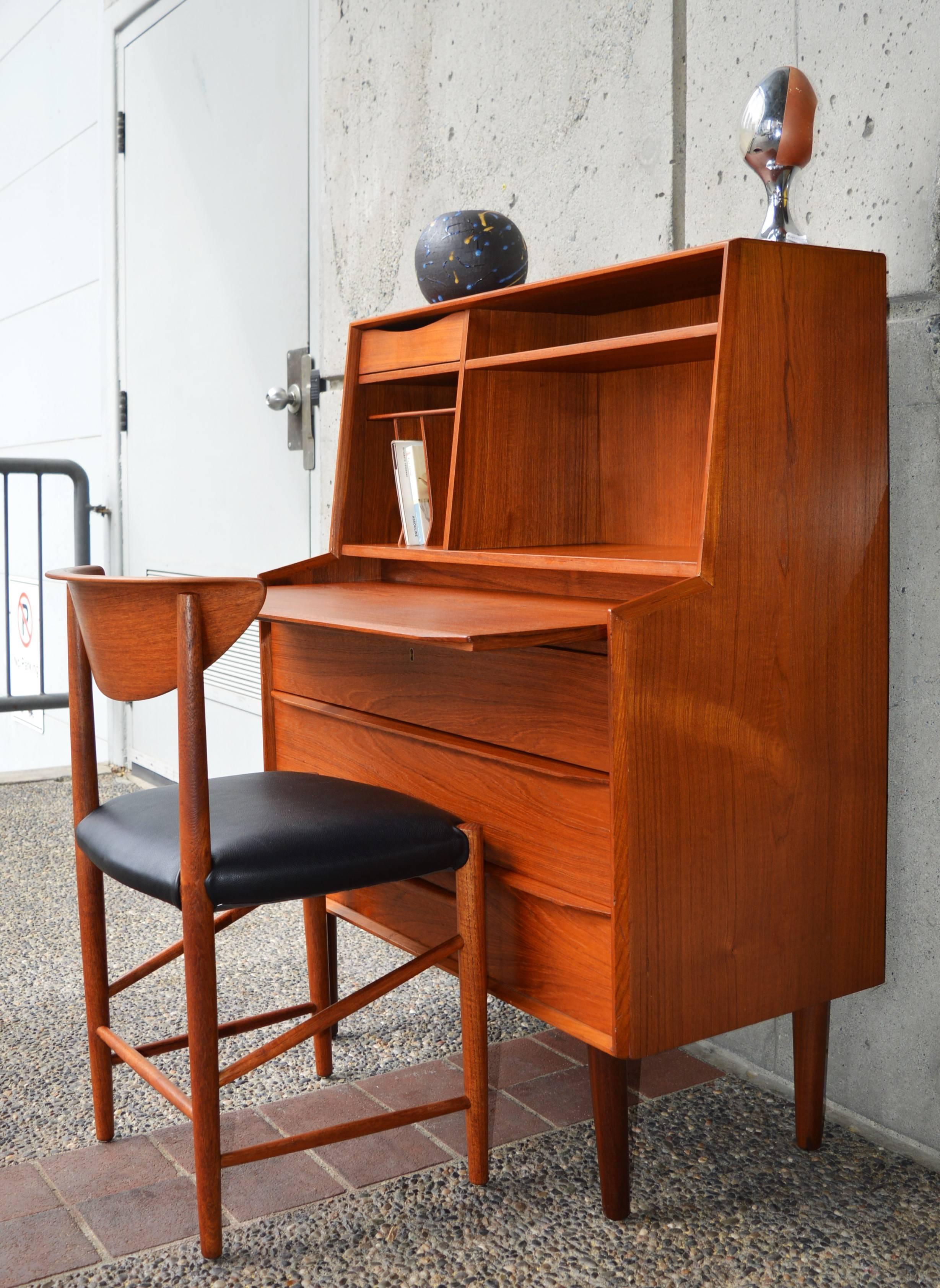 Super unique Danish modern teak secretary dresser with gorgeous and unique details throughout, such as the finger jointed top drawer with mirrored pull-out, and curved pigeon hole storage. Also the bevelled and curved lower drawer pulls that are