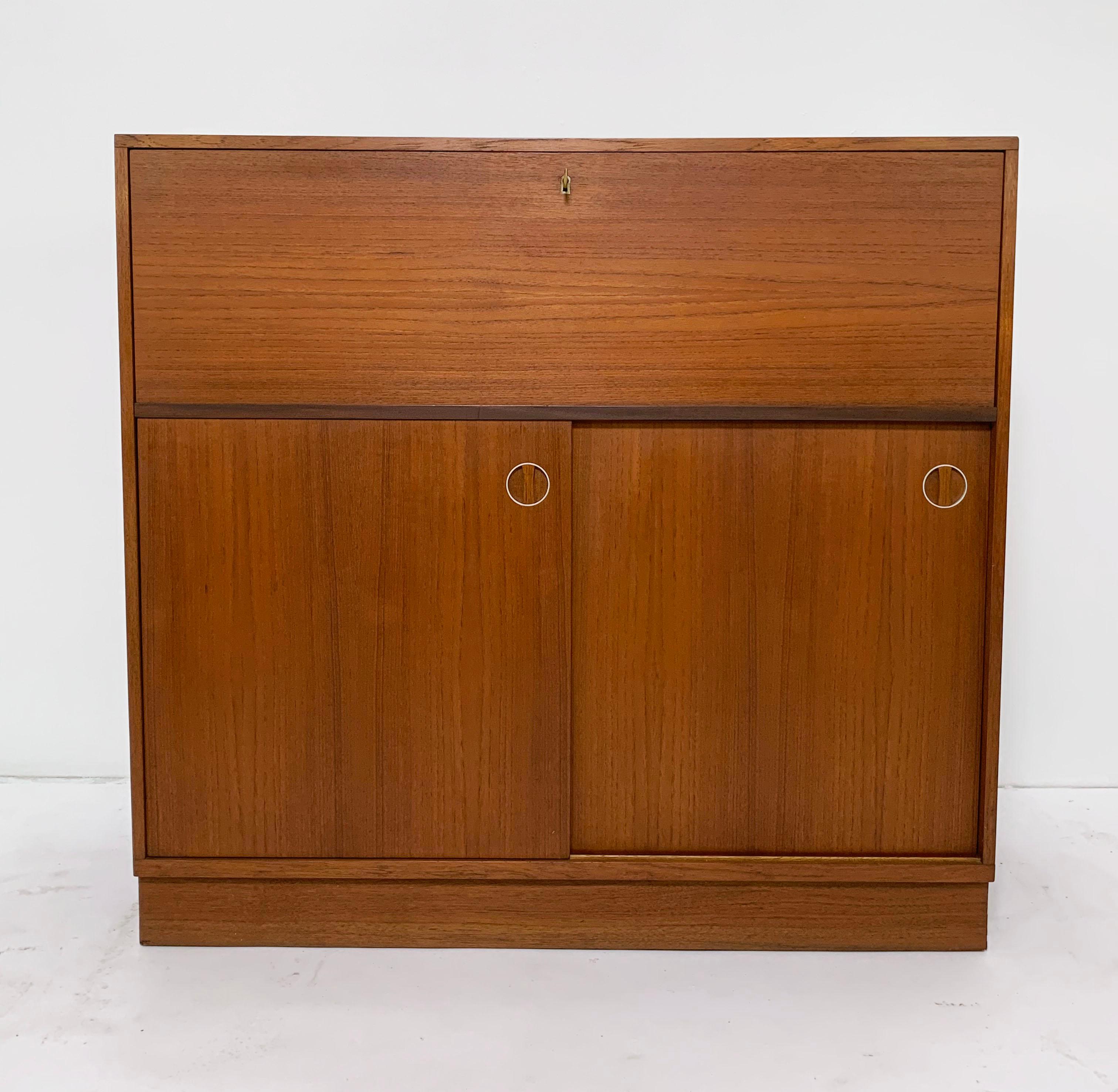 Teak secretary desk / cabinet, made in Sweden circa 1970s. Unusual finger joints at top edges. Drop down desk surface would make an excellent entry way unit.

When open, measures 23.5
